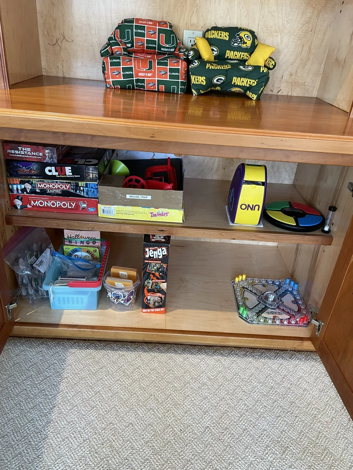 tidy and neat playroom cabinet in Bratenahl, Ohio after organizing by Declutter with Devon