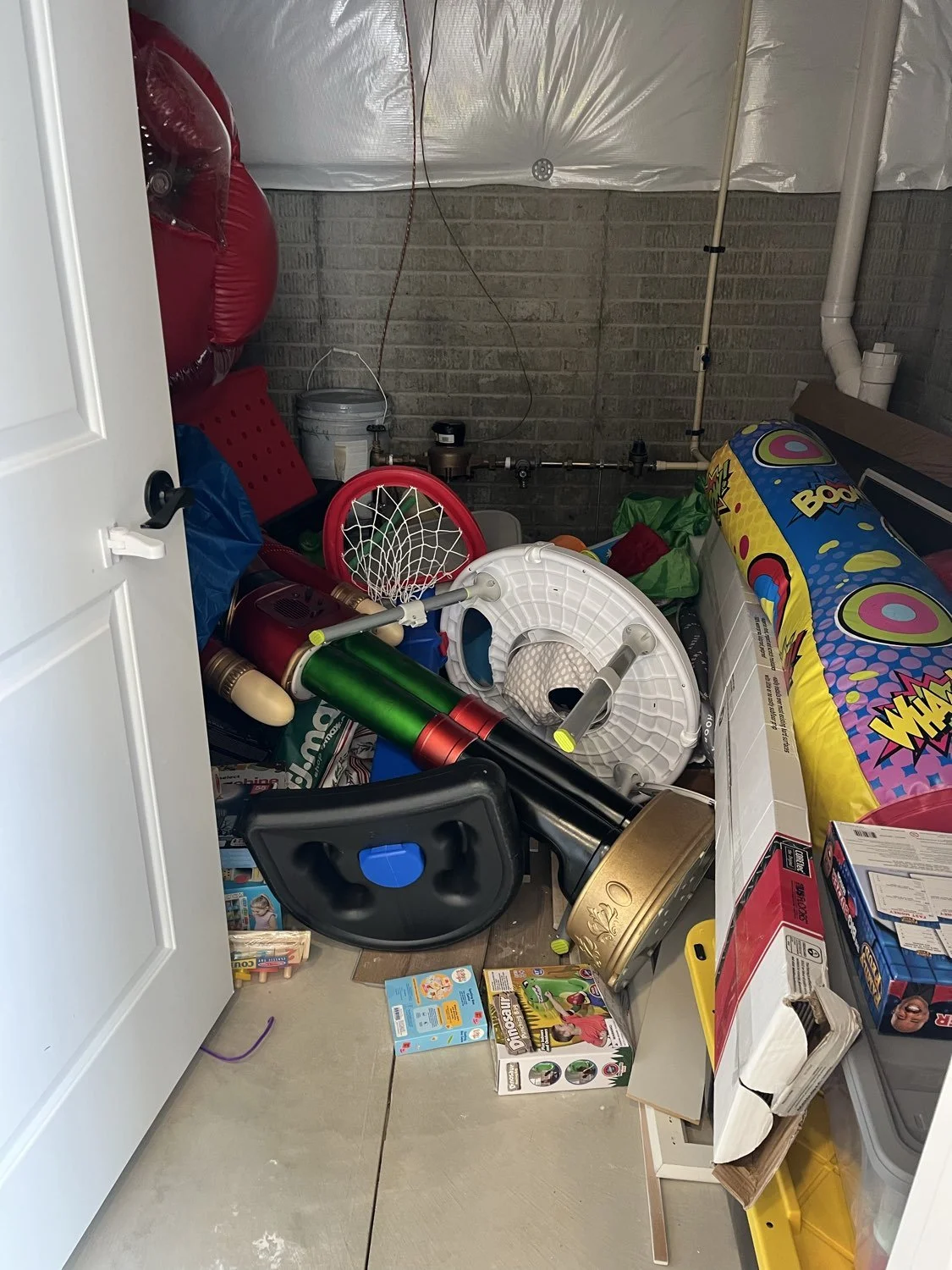 Crowded second basement storage room before organizing by Declutter with Devon in Broadview Heights