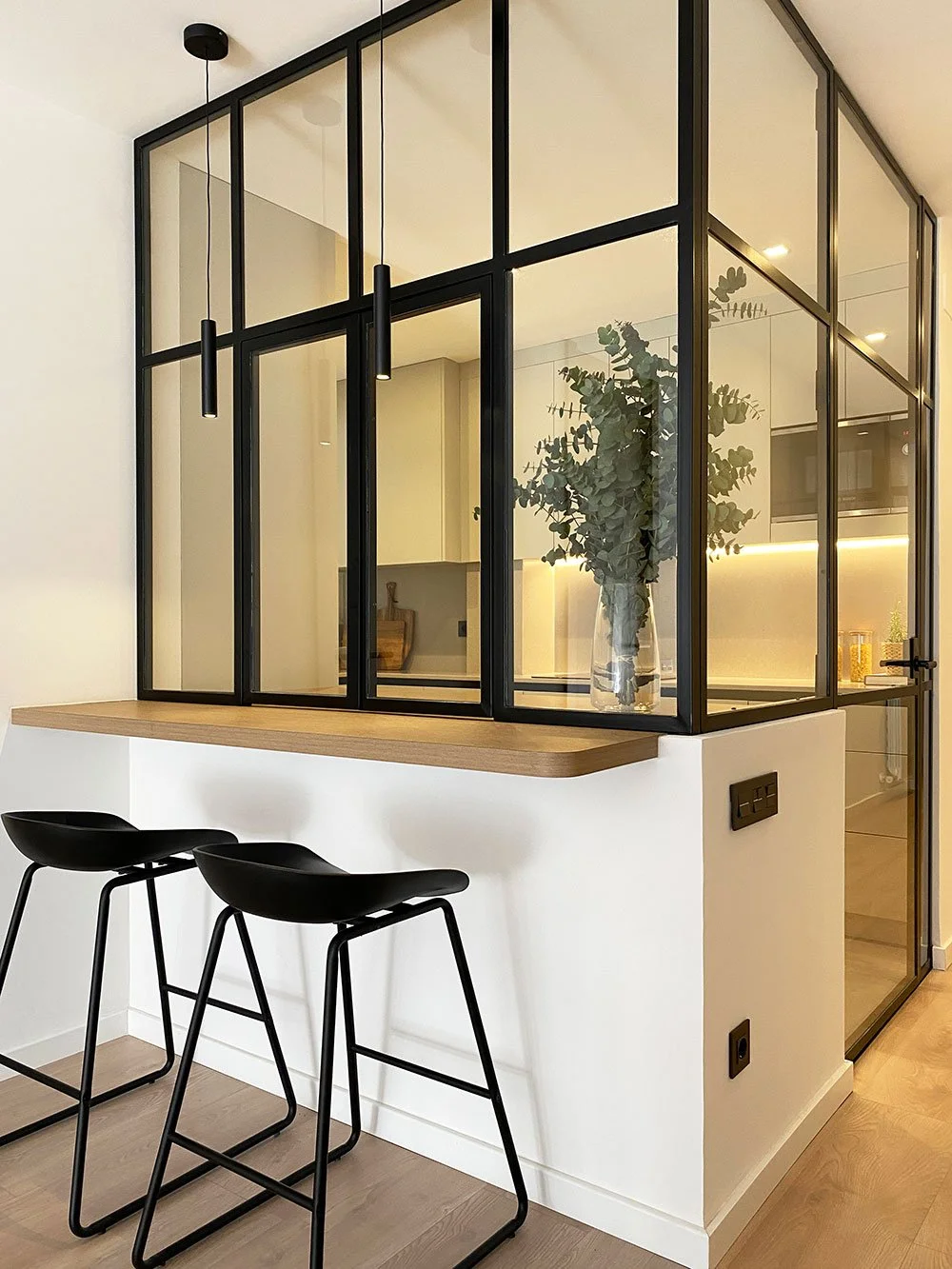 Contemporary apartment kitchen in Barcelona, Spain, featuring industrial minimalist interior design and bespoke cabinetry by MIA Studio.