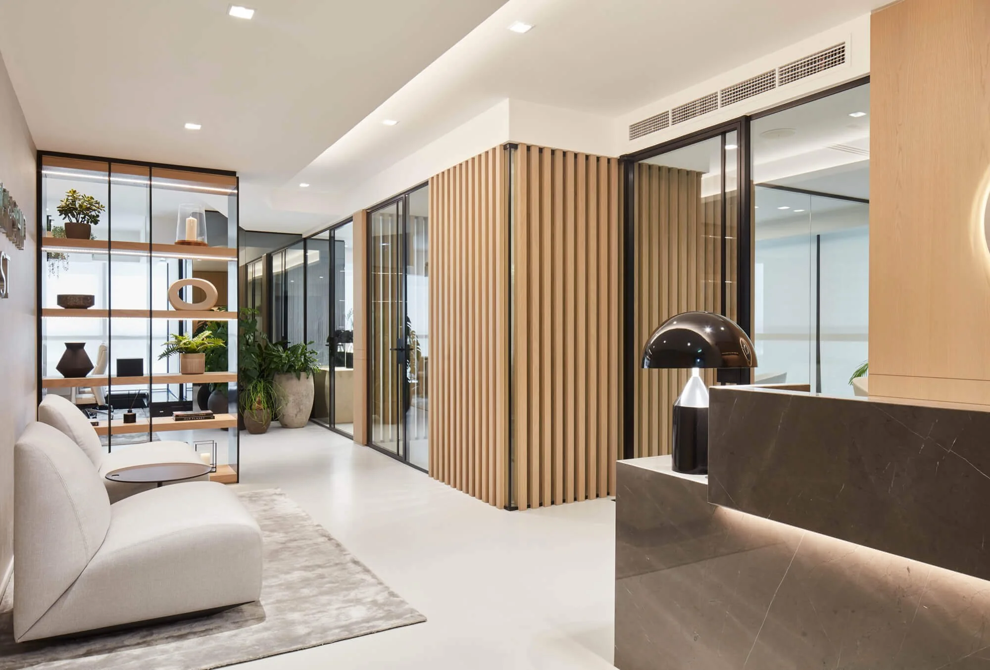 Contemporary office reception in Dubai featuring residential-inspired workplace interior design by MIA Studio.
