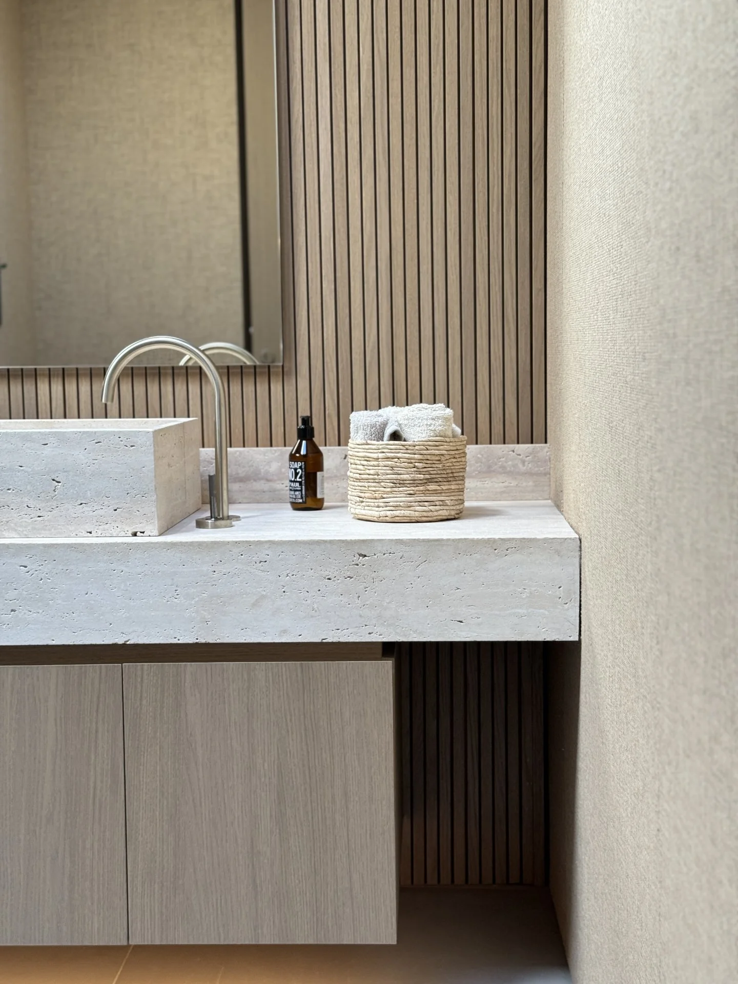 Luxury bathroom featuring bespoke vanity, natural materials and contemporary interior design by MIA Studio.