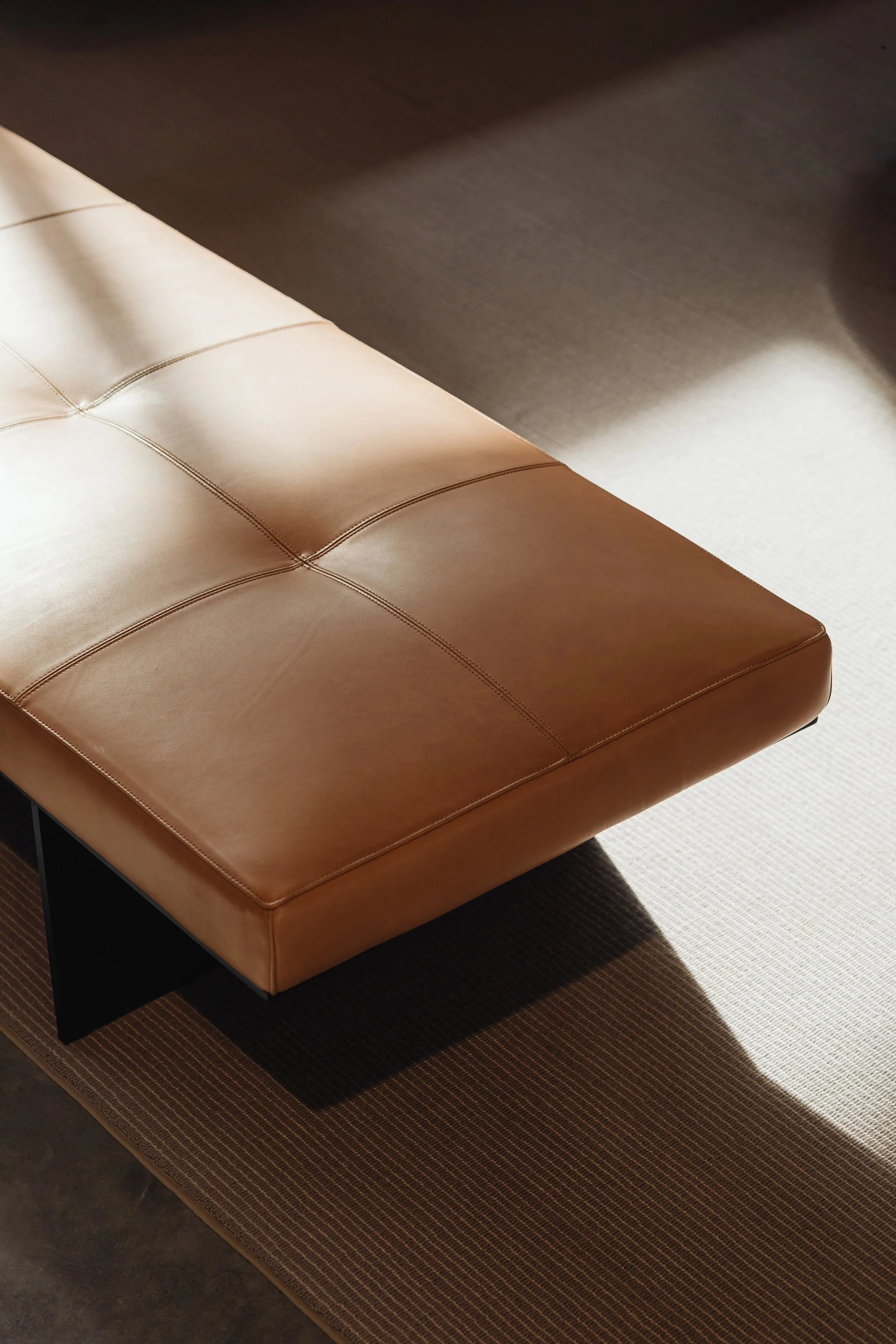 Custom leather bench with handcrafted detailing as part of a contemporary interior designed by MIA Studio.