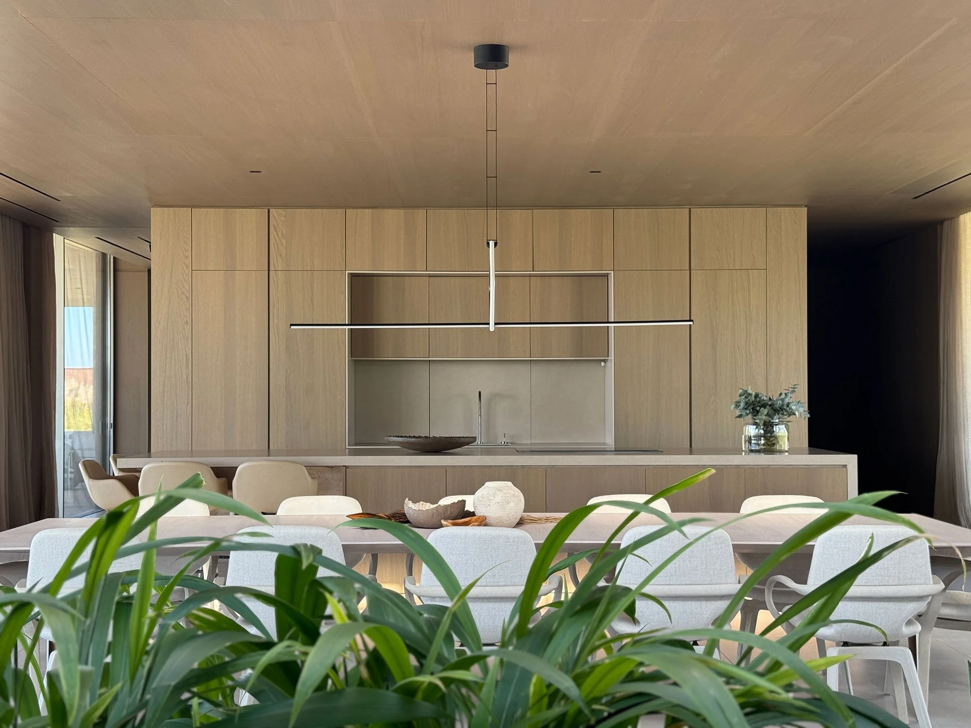 Luxury villa kitchen at Fasano Las Piedras, Punta del Este, featuring bespoke cabinetry and contemporary residential interior design by MIA Studio.