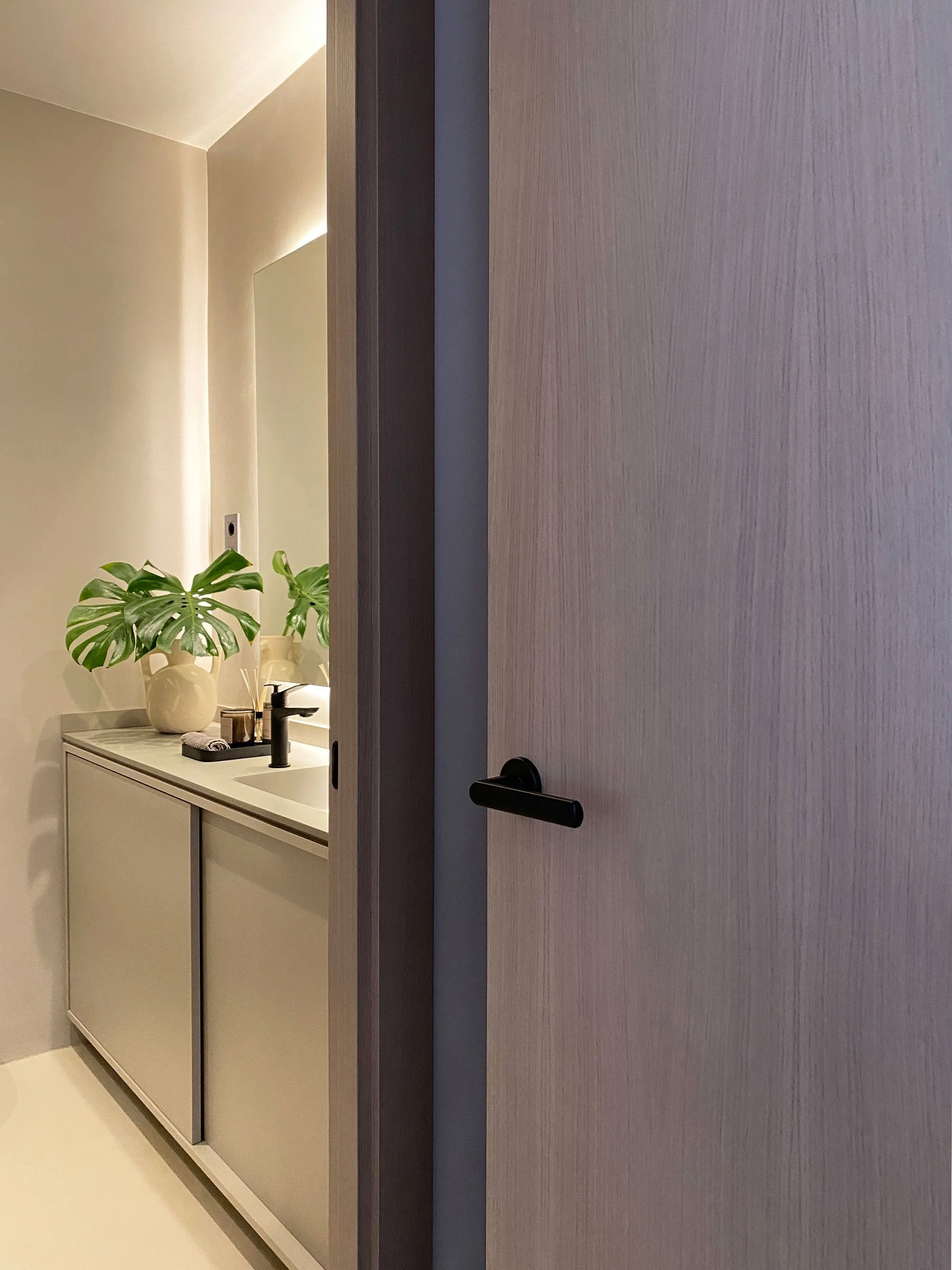 Contemporary bathroom in a renovated Barcelona apartment, featuring industrial minimalist interior design and bespoke detailing by MIA Studio.