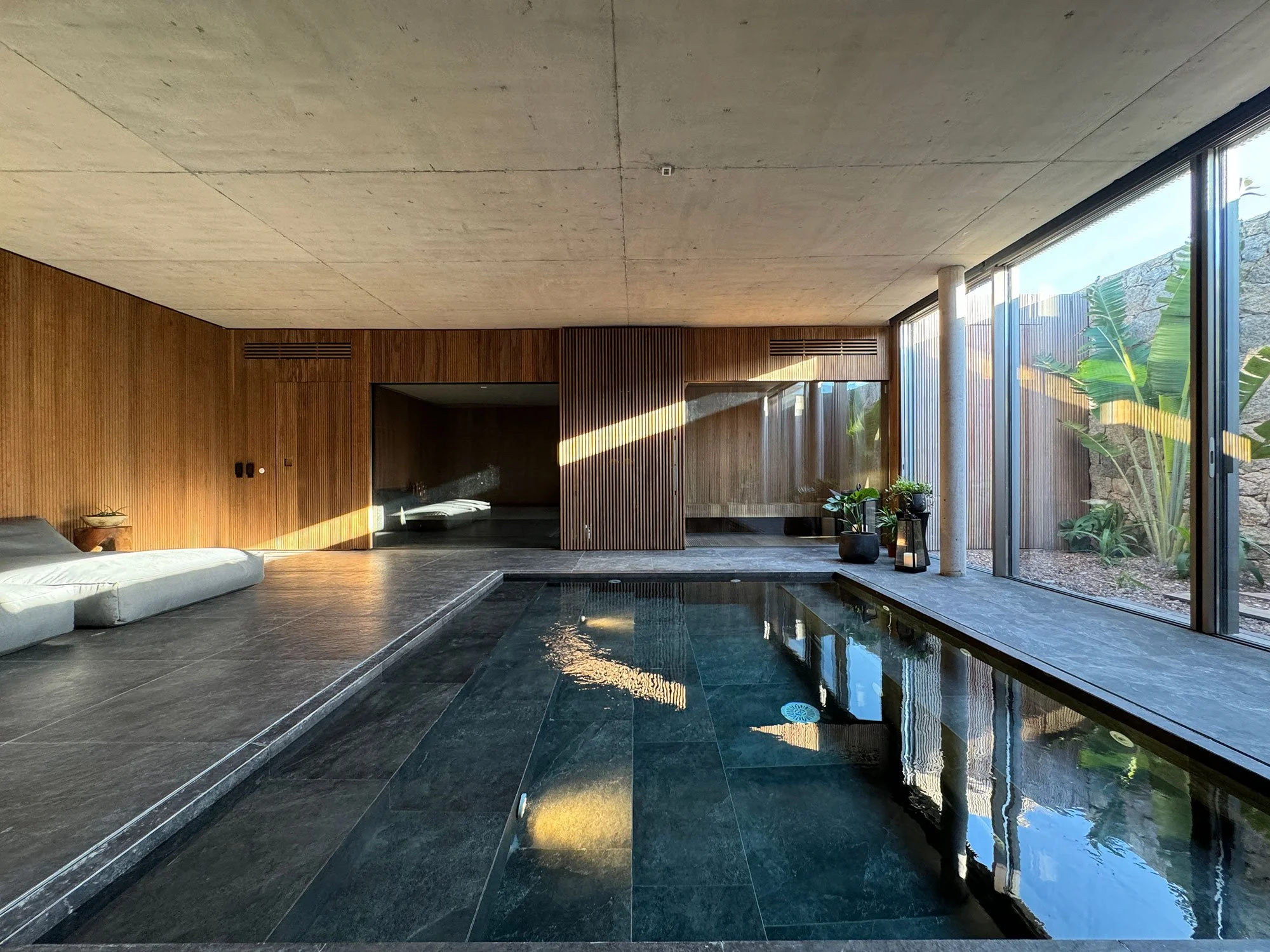 Luxury home spa at Fasano Las Piedras, Punta del Este, featuring contemporary wellness interior design with timber, stone and a built-in jacuzzi by MIA Studio.