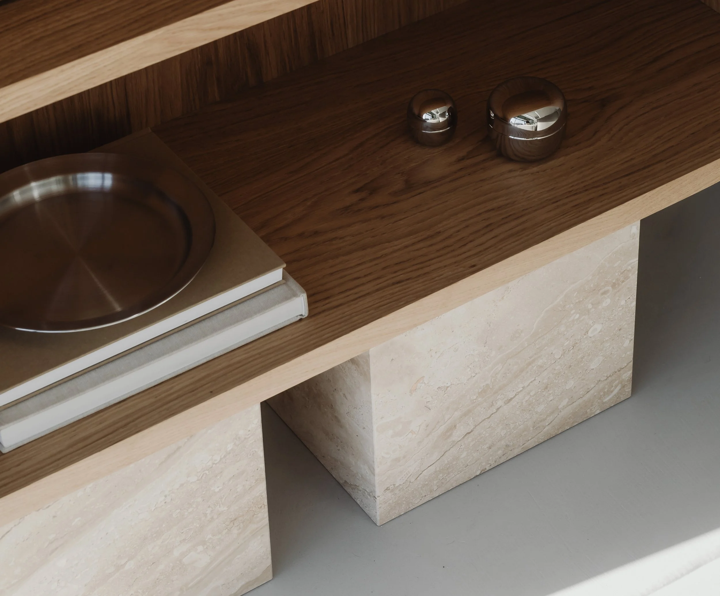 Custom timber joinery featuring integrated shelving and curated decorative styling by MIA Studio.