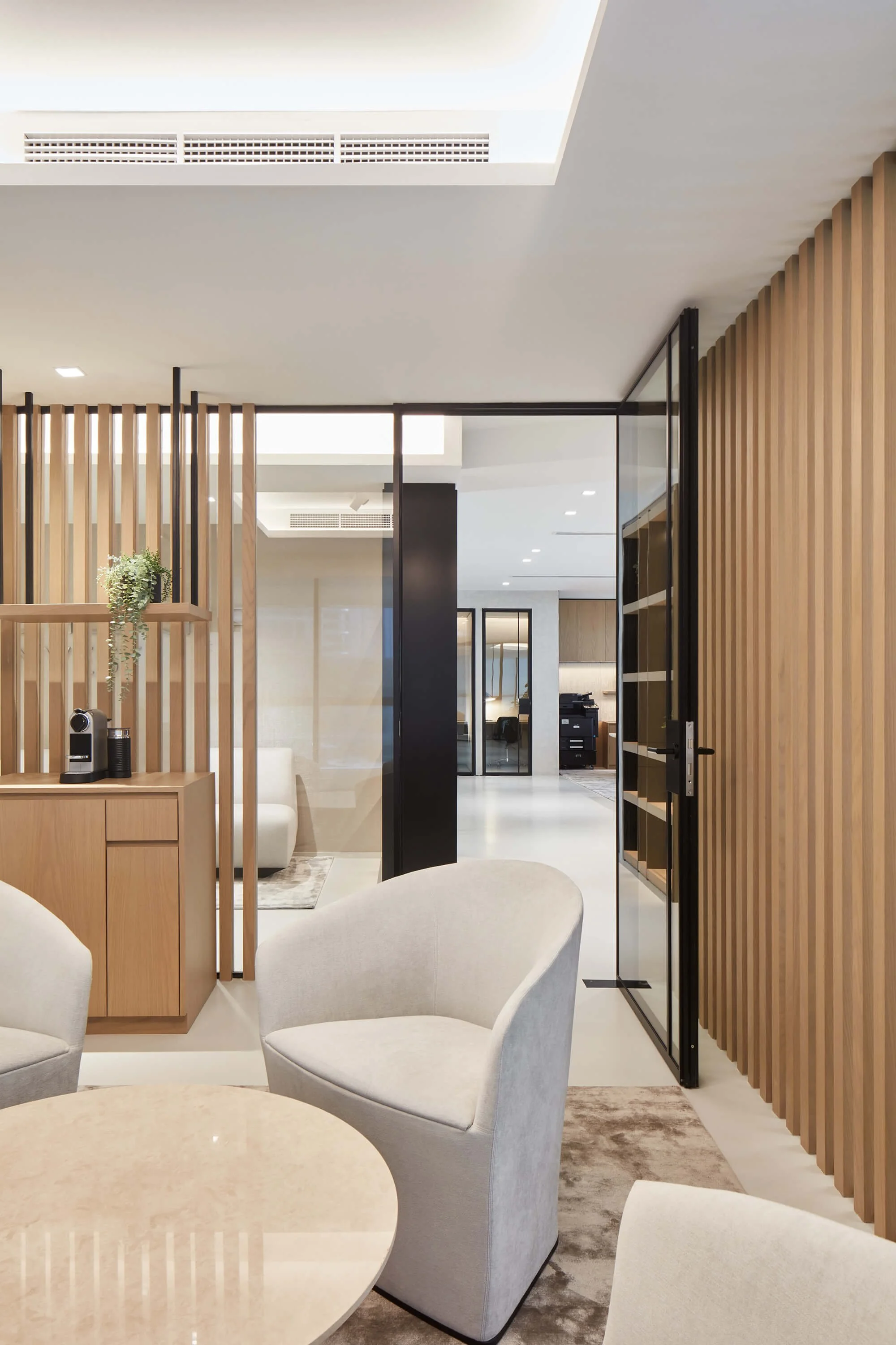 Modern meeting room with residential-inspired interior design, featuring bespoke timber joinery and elegant lighting by MIA Studio.