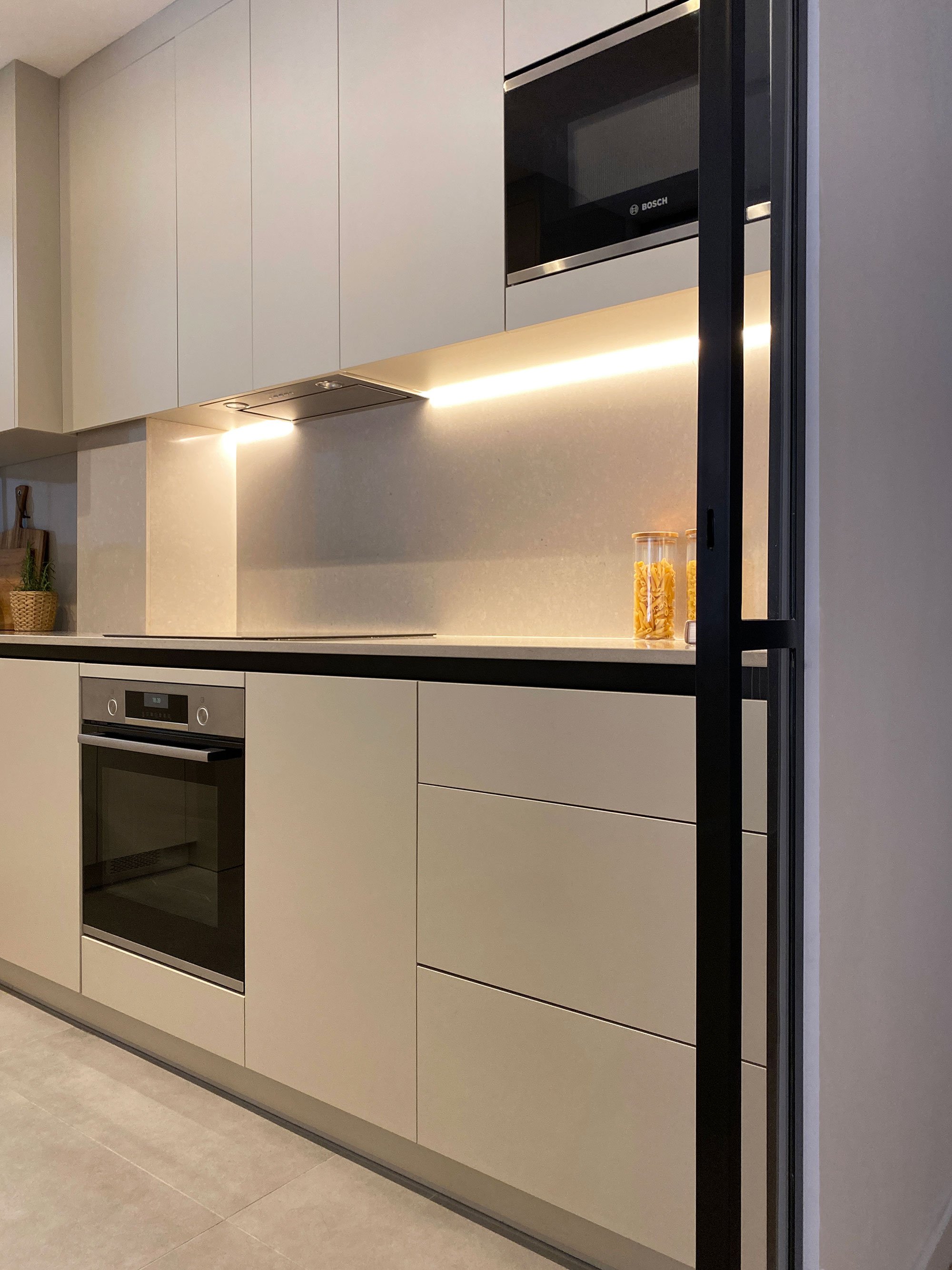 Contemporary apartment kitchen in Barcelona, Spain, featuring industrial minimalist interior design and bespoke cabinetry by MIA Studio.