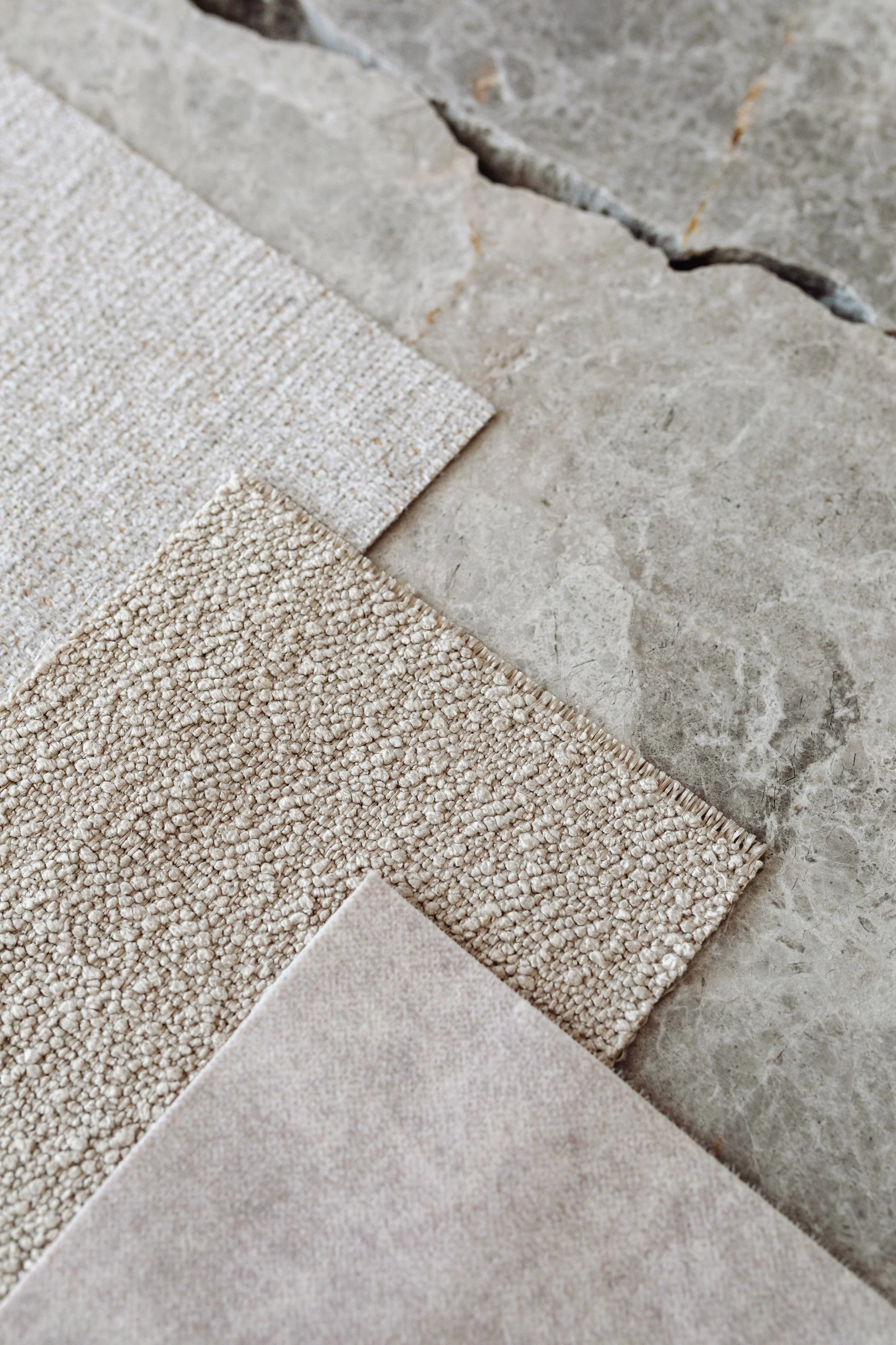 Natural stone and textured flooring materials selected to create a timeless contemporary interior by MIA Studio.