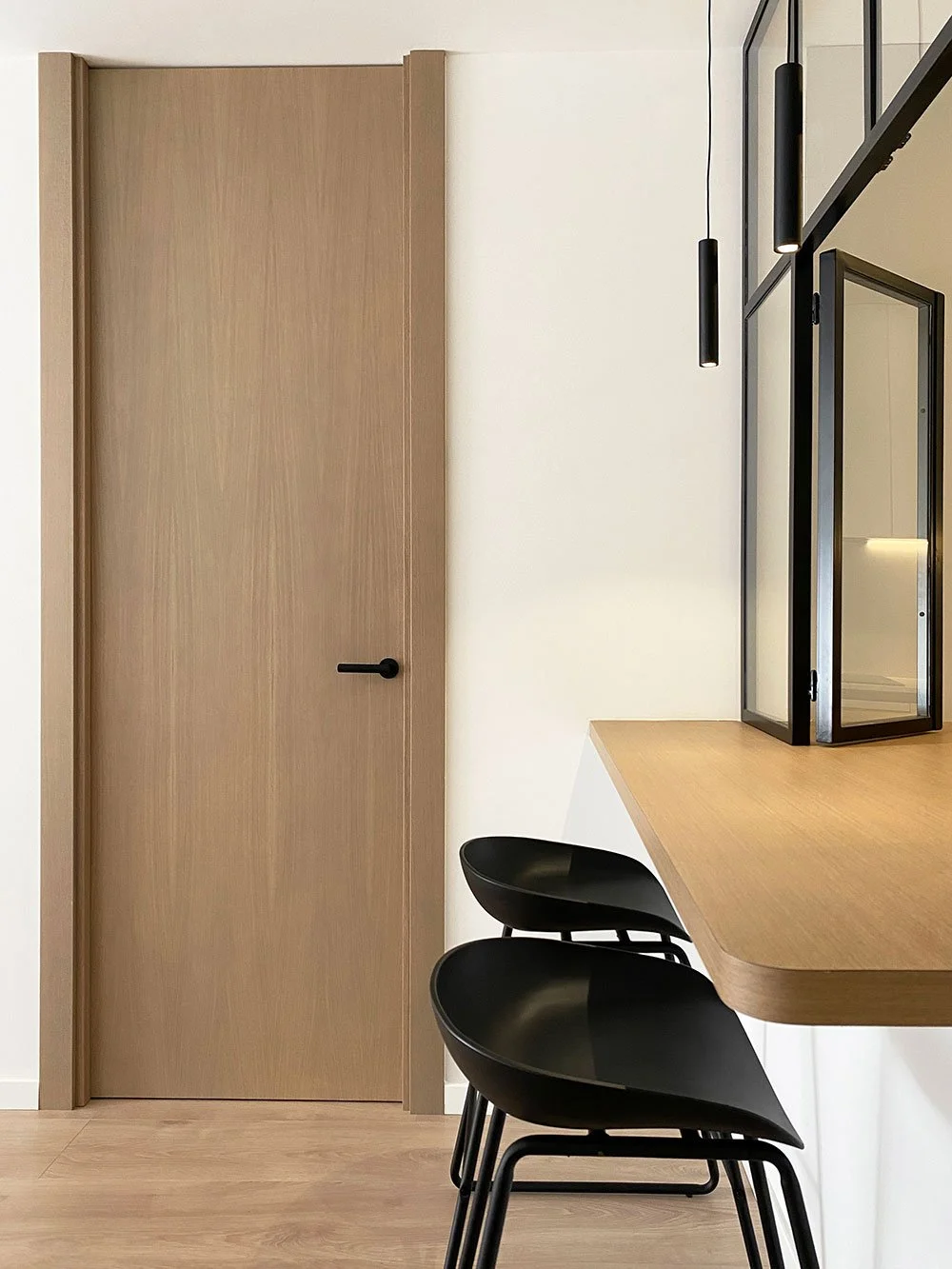 Contemporary apartment renovation in Barcelona, Spain, featuring industrial minimalist interior design with glass partitions by MIA Studio.
