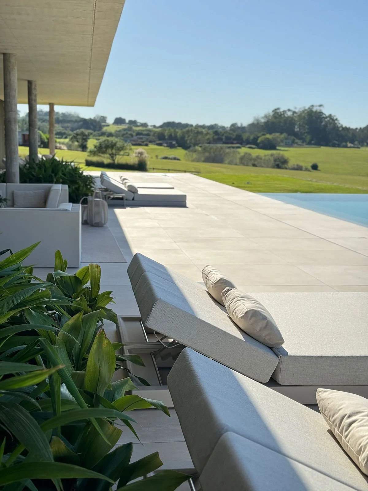 Luxury pool terrace at Fasano Las Piedras, Punta del Este, designed for outdoor living with contemporary furnishings by MIA Studio.