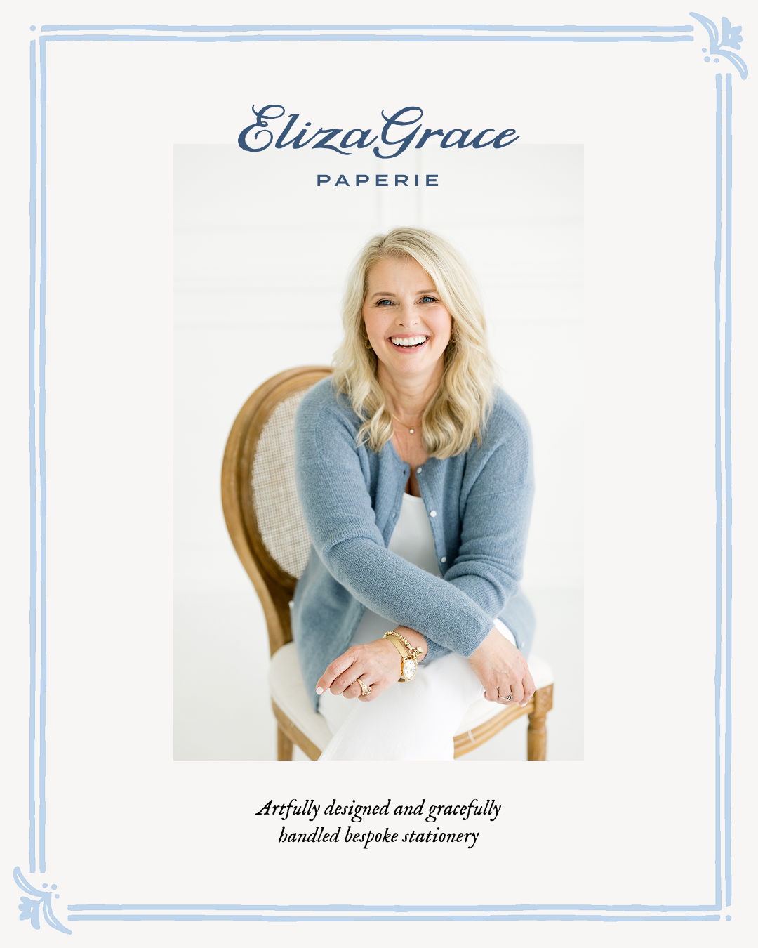 A portrait of a person seated on a wooden chair wearing a soft blue cardigan and white outfit, framed with blue flourishes and featuring the Eliza Grace Paperie logo and tagline.