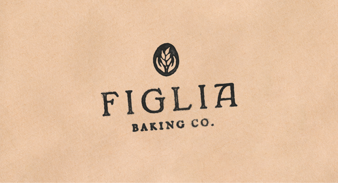 A beige background featuring the Figlia Baking Co. logo: a small black wheat emblem above bold serif text reading “Figlia Baking Co.”