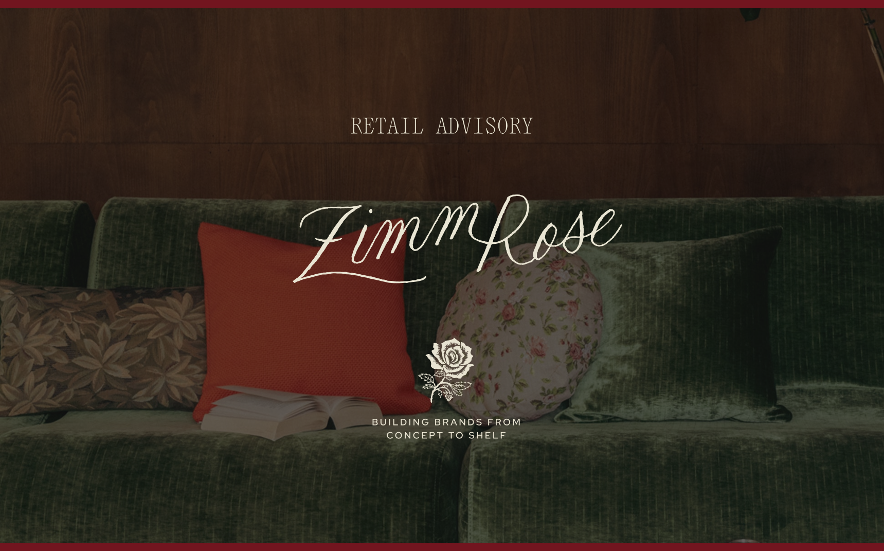 A green velvet couch with floral and solid-colored pillows, an open book resting on the seat, and overlaid text reading “Retail Advisory – ZimmRose – Building Brands From Concept to Shelf,” creating a warm, sophisticated brand atmosphere.