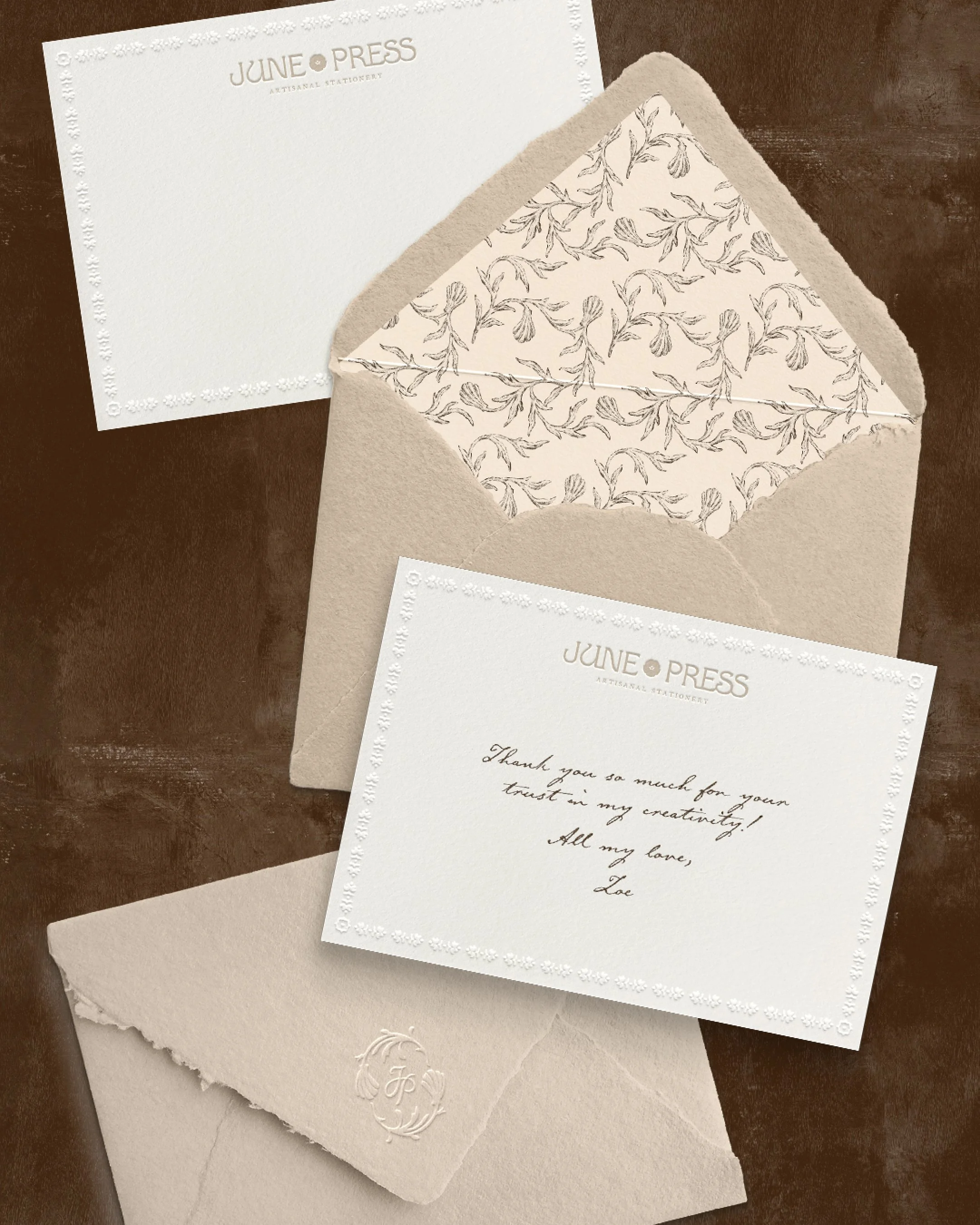 Luxury wedding stationery design for June Press featuring textured paper, deckled edge envelopes, and coastal floral pattern lining