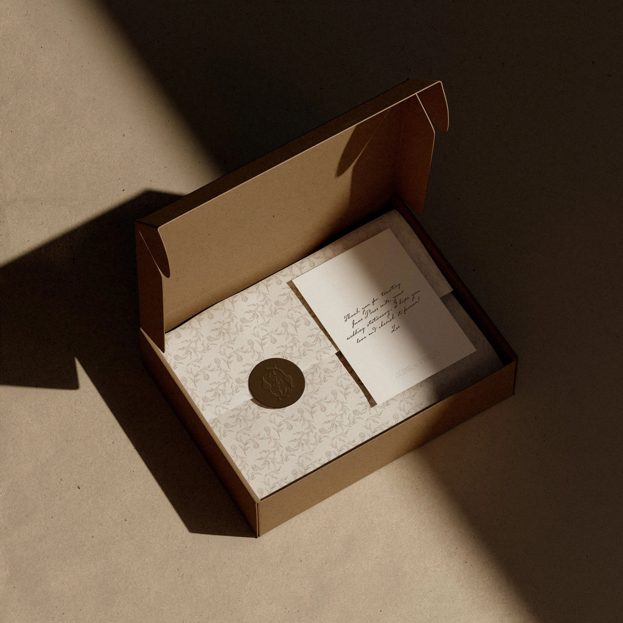 Bespoke brand packaging design with custom stationery, logo seal, and elegant unboxing experience
