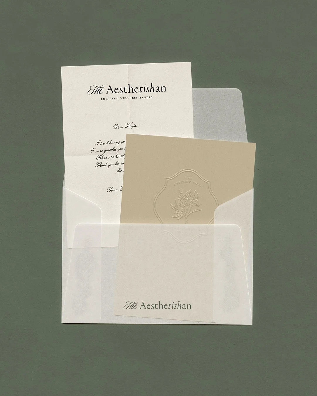 Luxury branding for The Aesthetishan featuring custom stationery suite with embossed logo, textured paper, and cohesive skincare brand identity