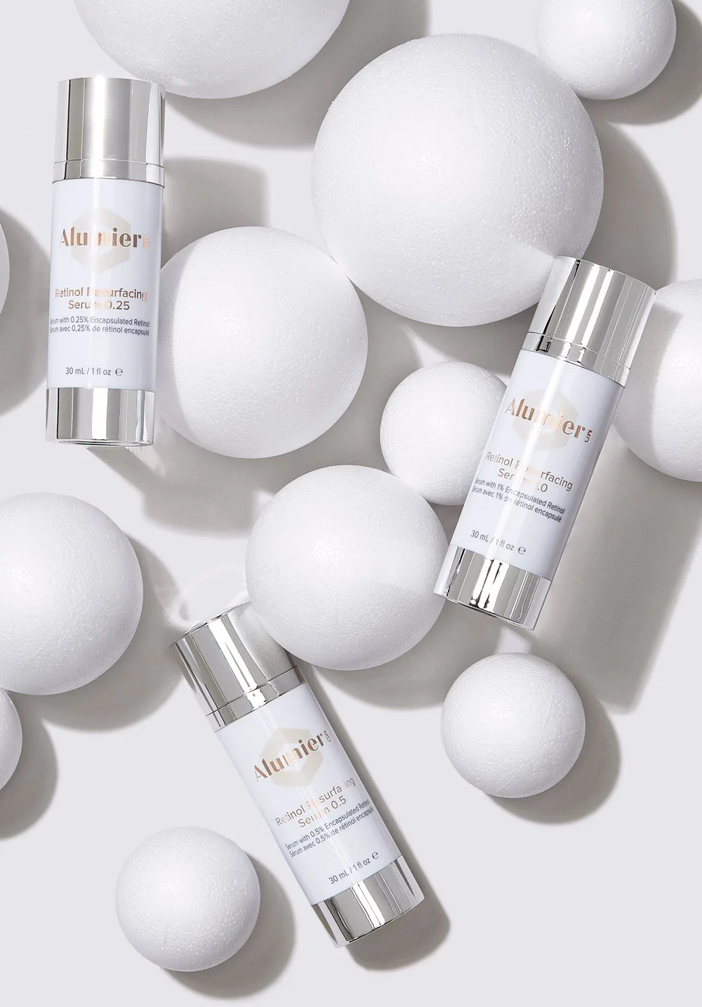 Alumier MD Retinol Resurfacing Serum bottles with white spheres.