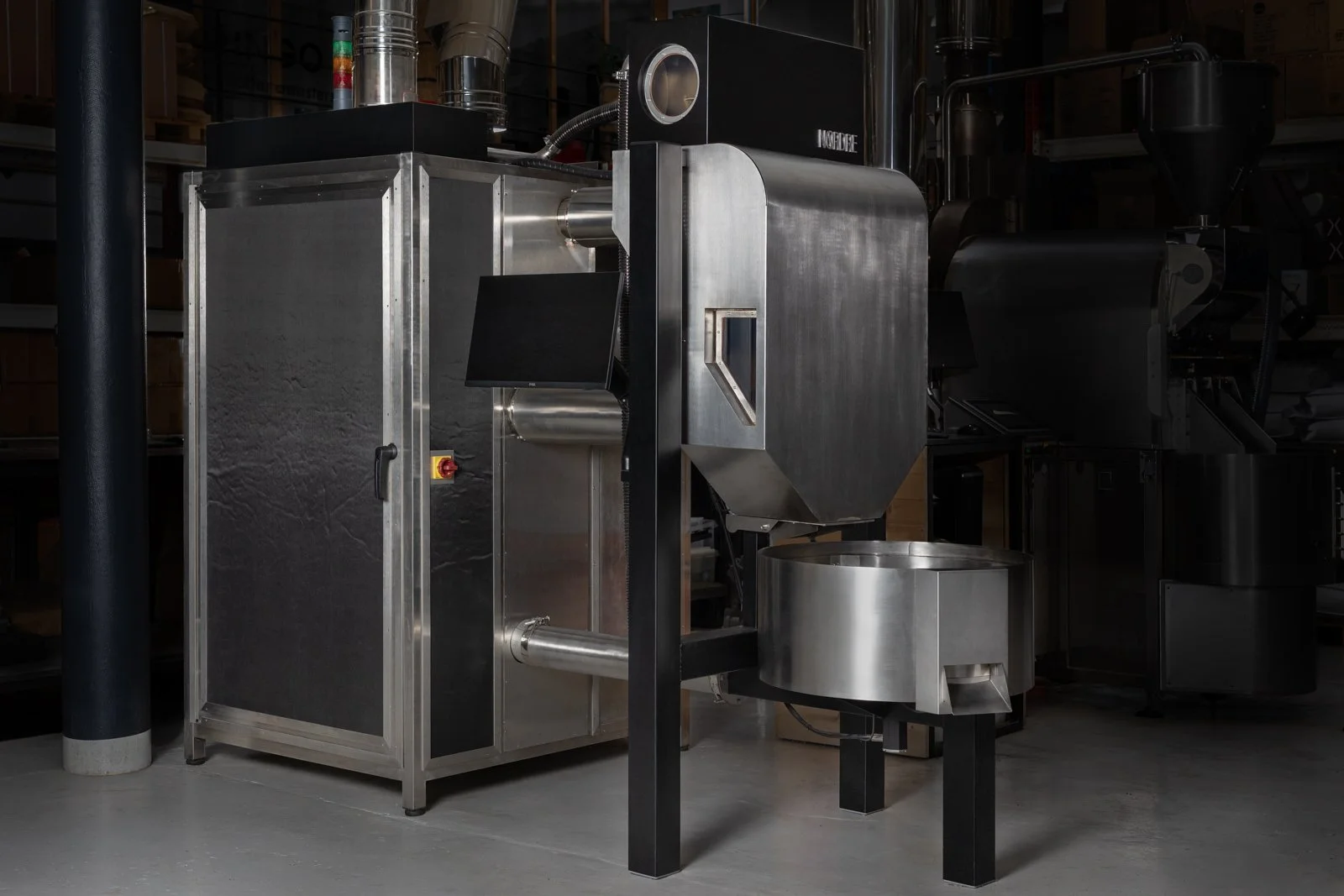 NORDRE EMBLA coffee roaster with control panel and exhaust piping in the workshop