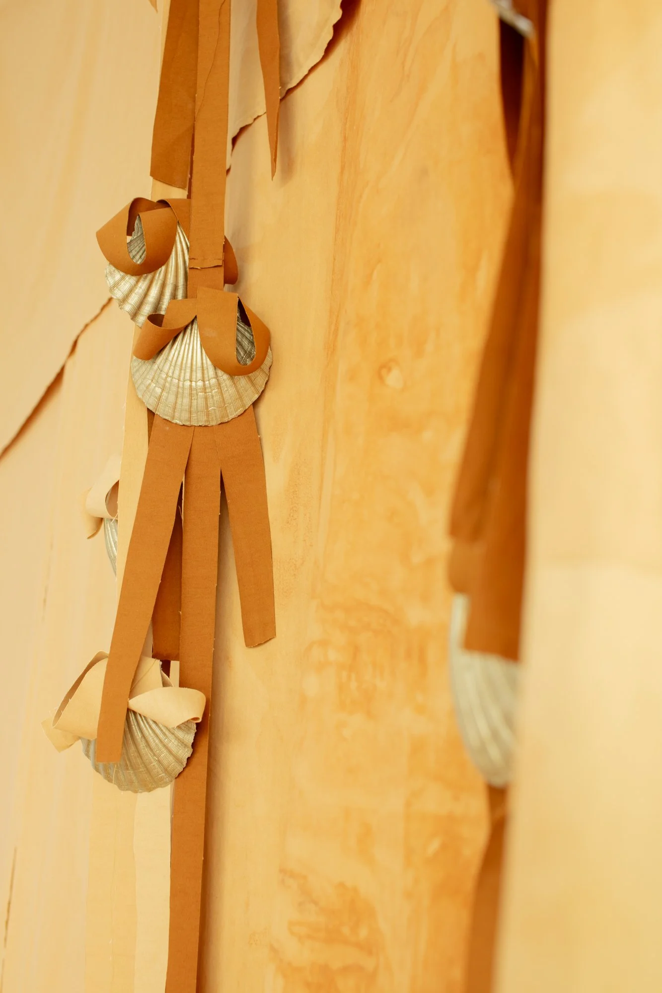 Shells and strips of coloured canvas