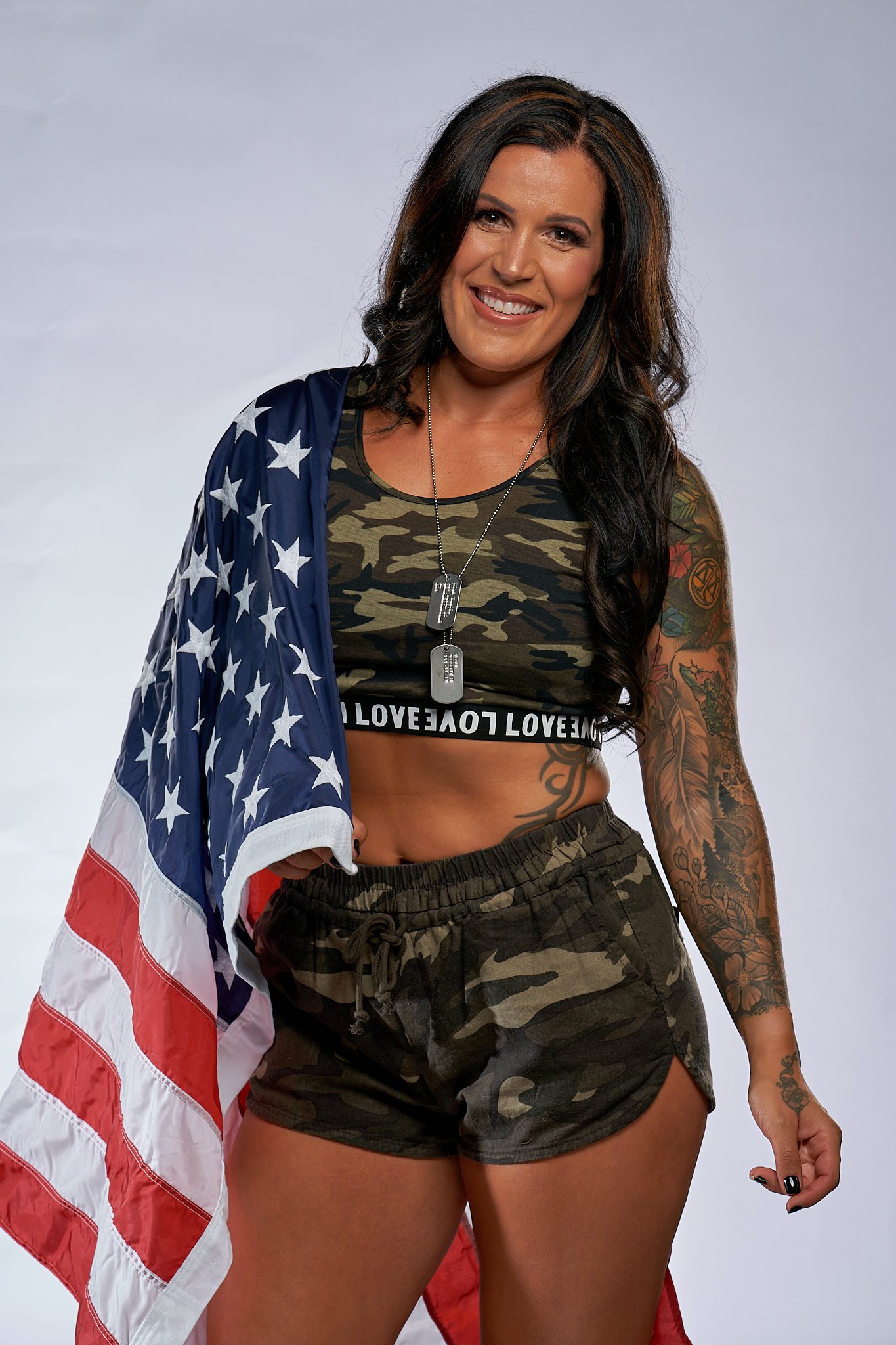  US Army Veteran, Fitness Model draped in American Flag during her fitness photoshoot 