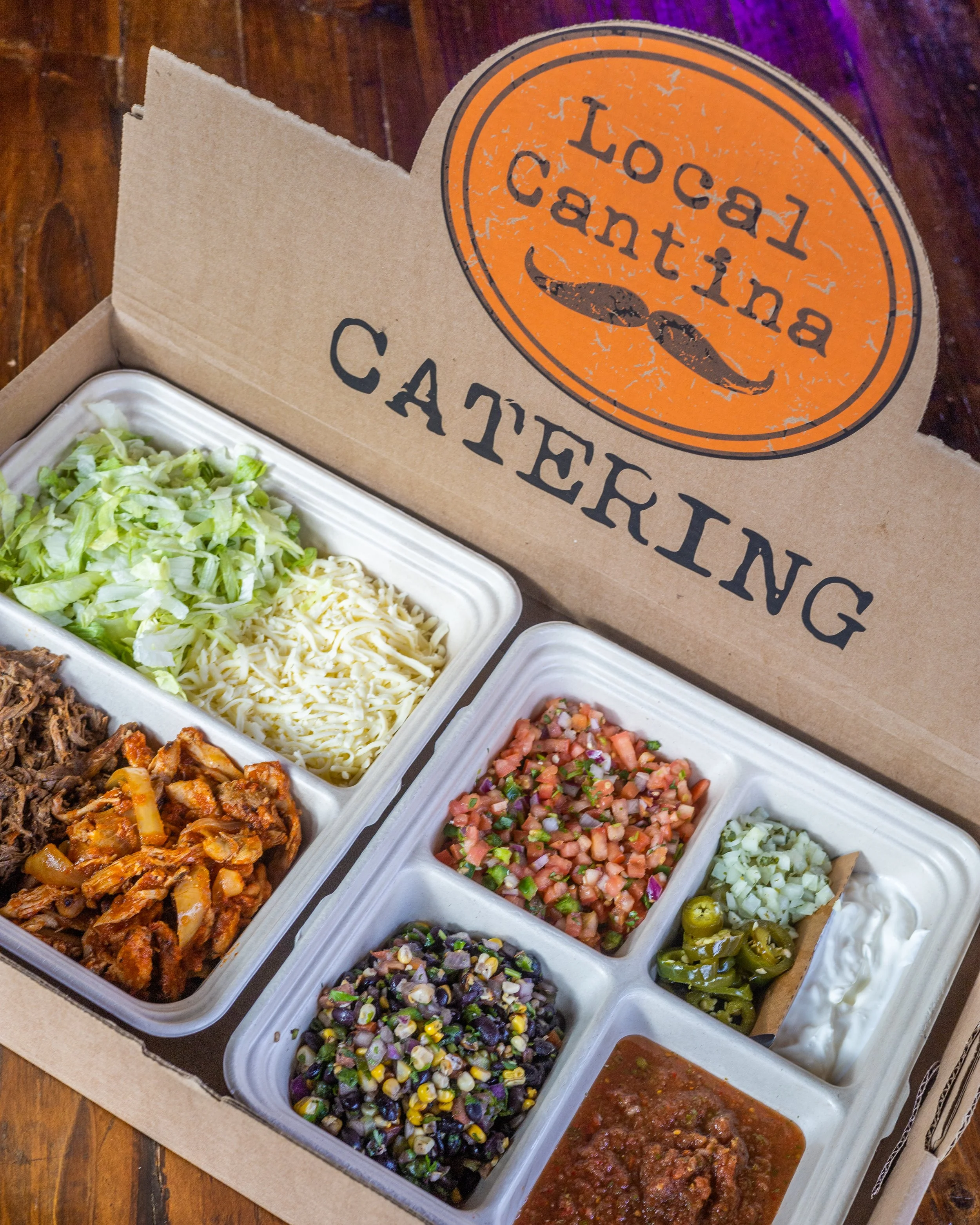 Local Cantina catering taco bar with shredded chicken, beef, queso, salsa, and toppings in Columbus Ohio