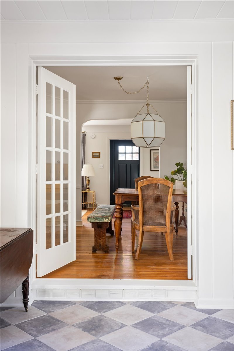 Classic Checkered Tile Sunroom with Cozy Dining Room