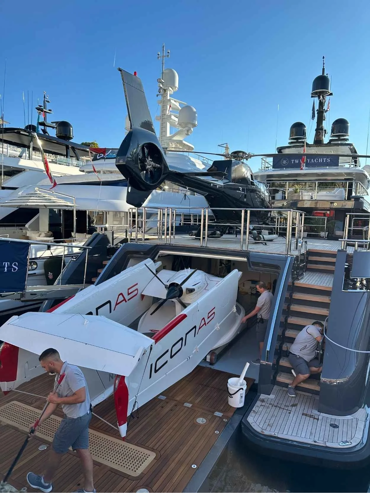 Two helicopters parked on a yacht.