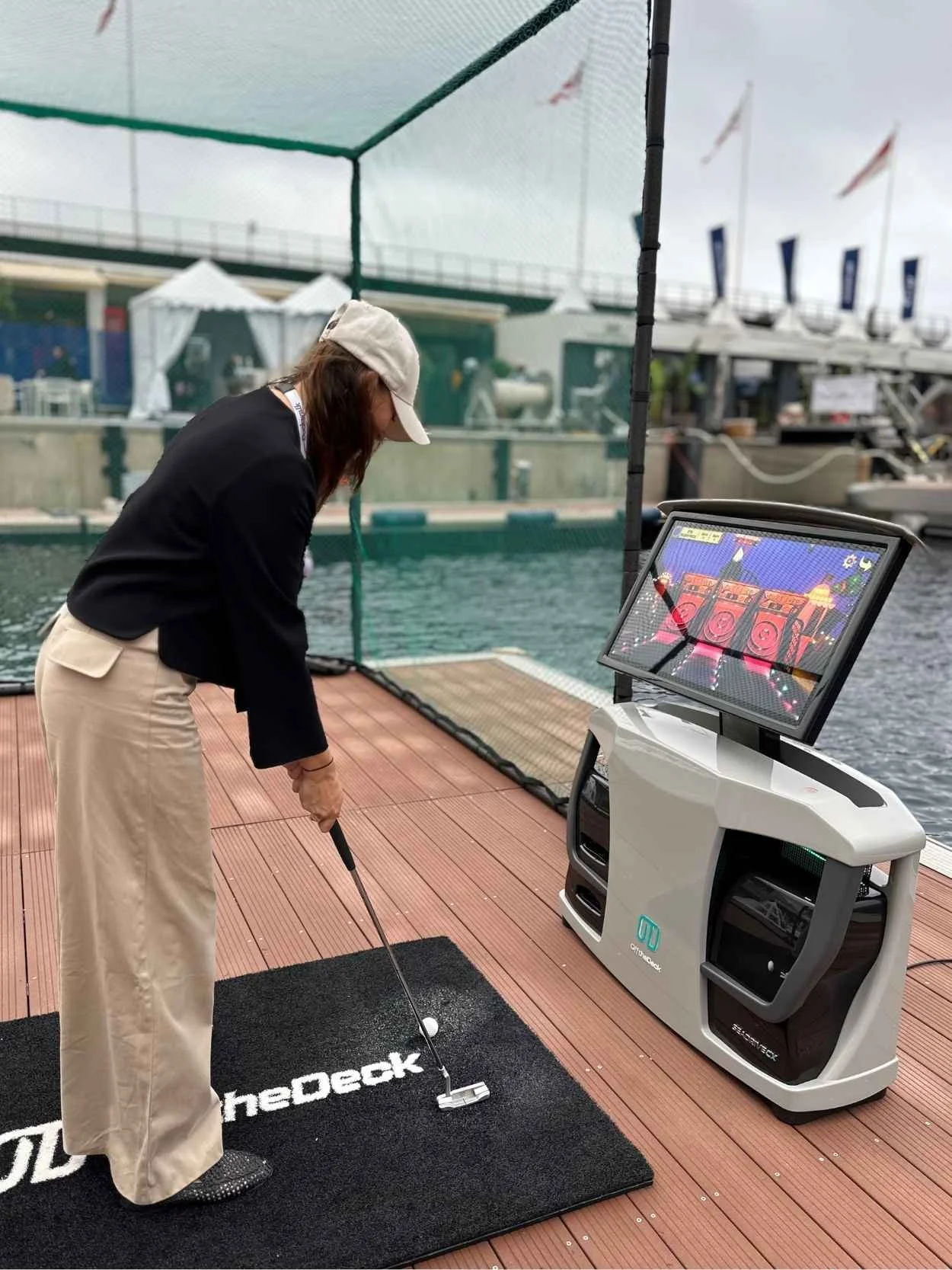 Woman practicing a put on the SeaDriveCX, stood by the protective mesh.