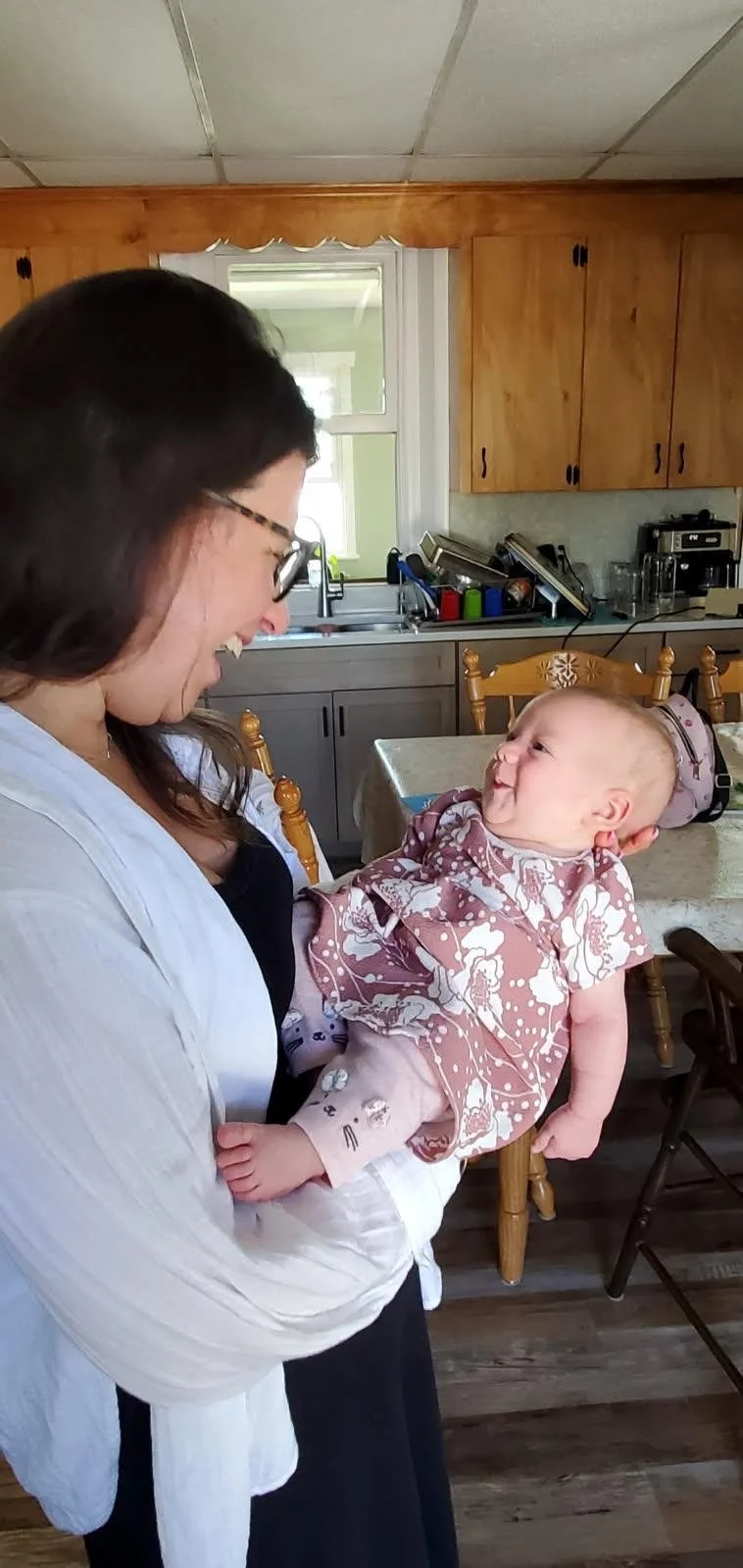 6 week postpartum home visit. Client wanted a photo of midwife Elizabeth holding her baby