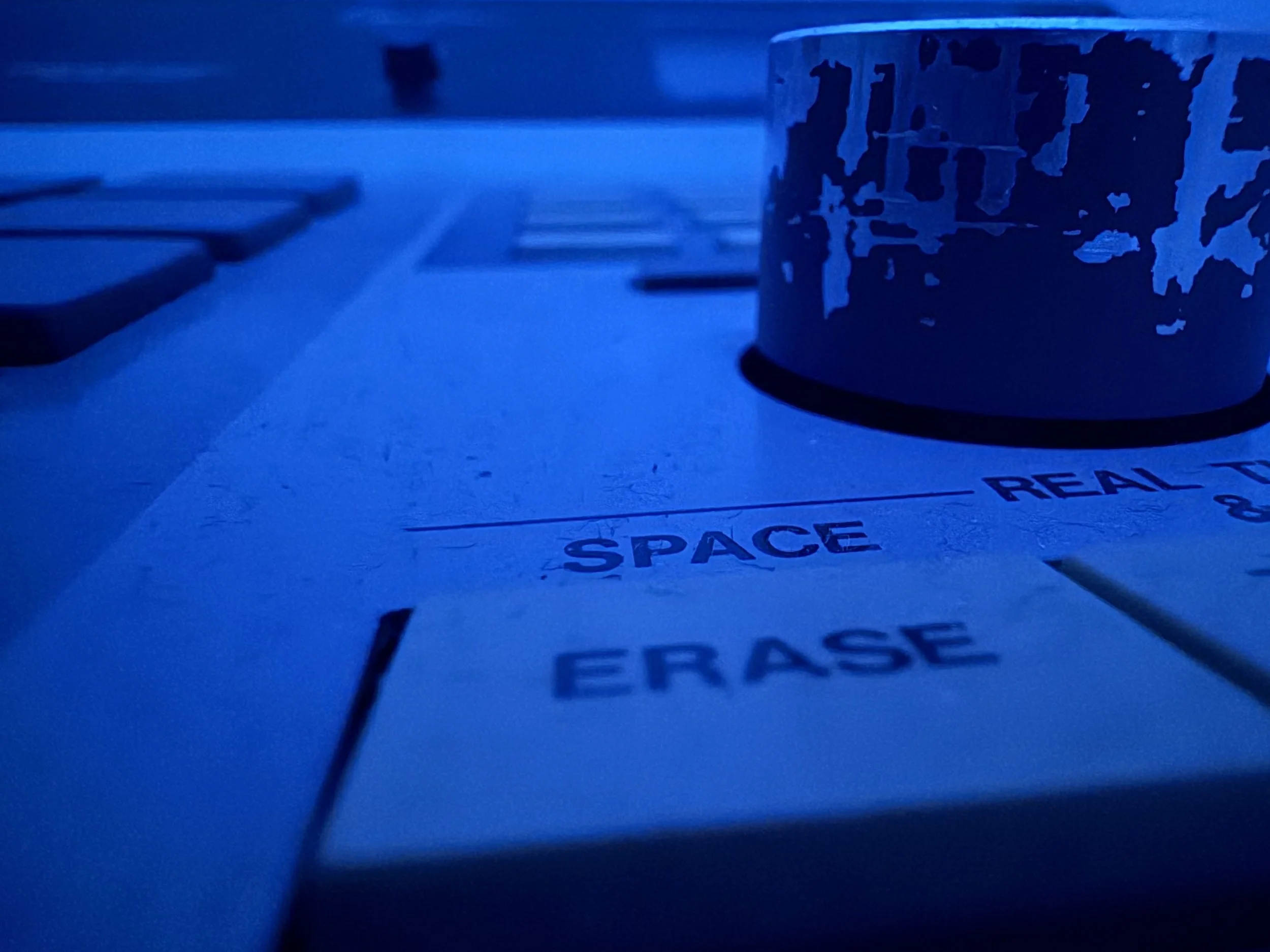 Macro photo of a creative audio tool with Space and Erase labels.