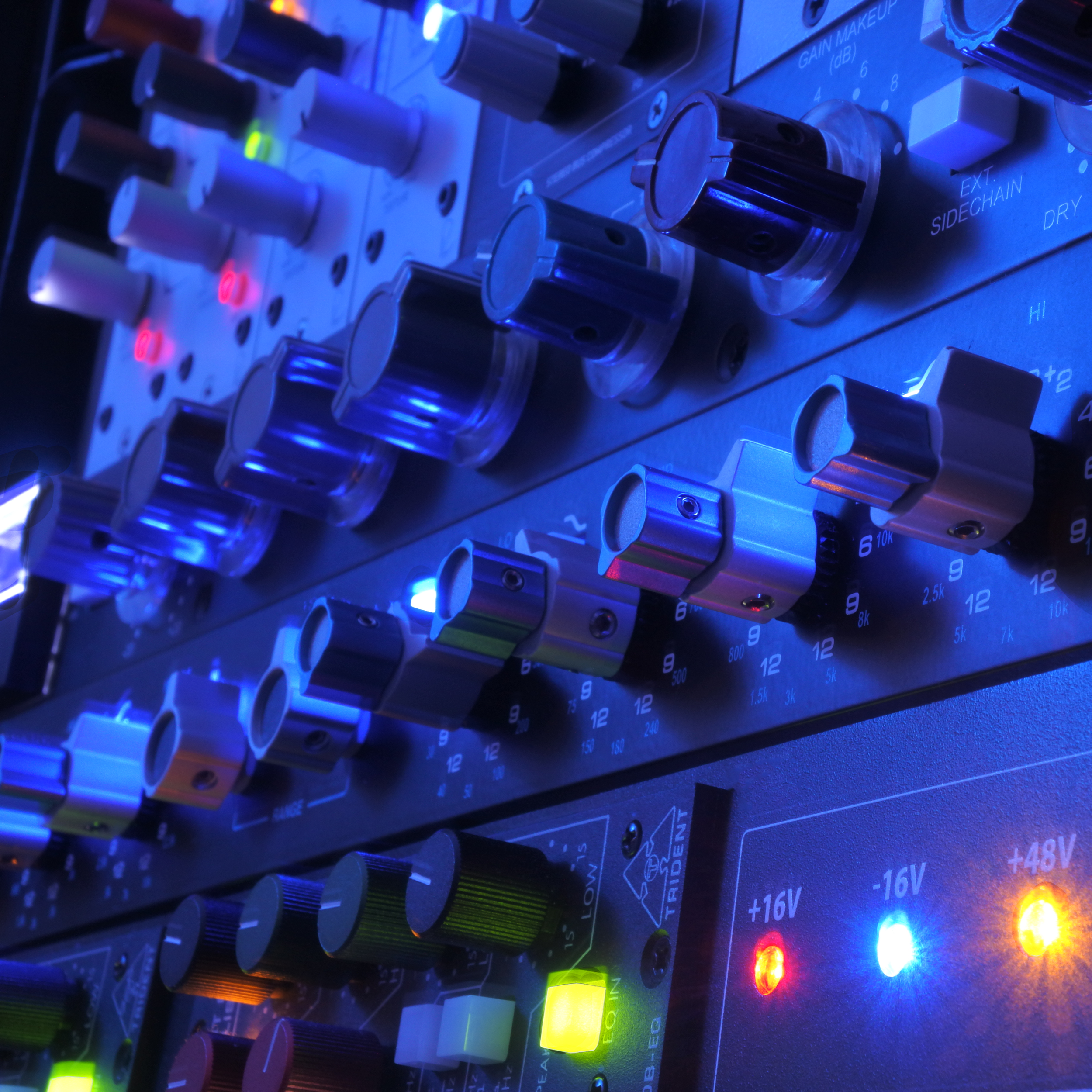 Close-up of analog studio hardware used in a hybrid audio workflow.