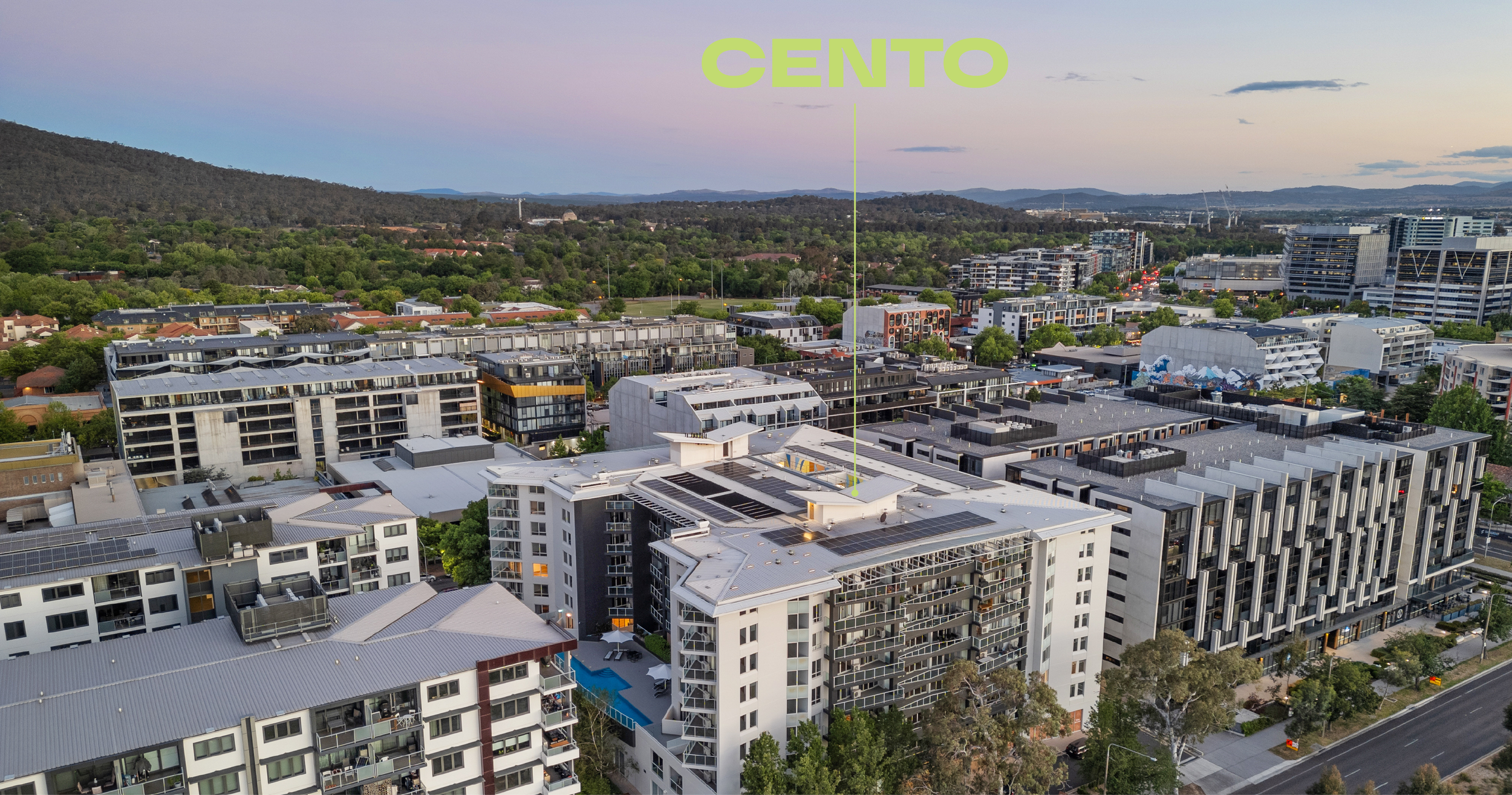 Aerial view of Canberra's Braddon and Civic showing residential buildings, parks, and Mount Ainslie at dusk.