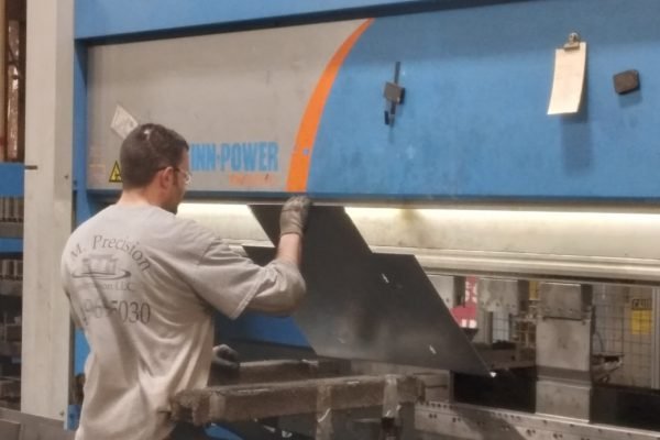 Bending the steel to custom-build various sizes of enclosures.
