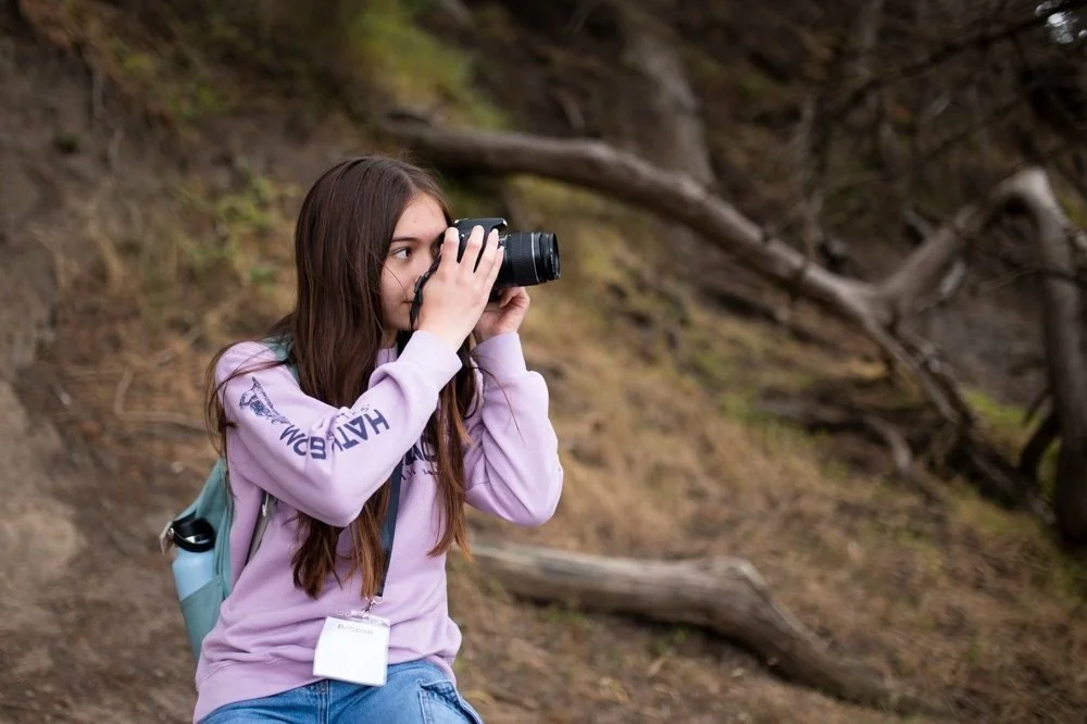 A student pracitcing photography during a photography class or workshop in the San Francisco Bay Area where teens and adults learn about photography.
