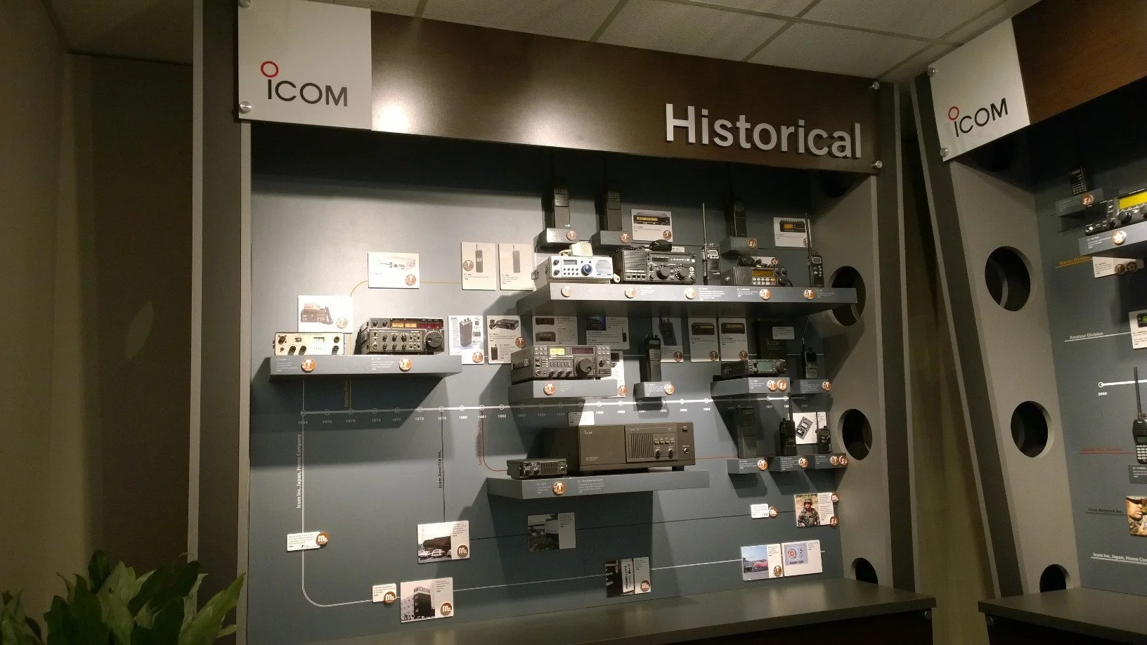 A short wall named "Historical" features a timeline of radios, represented in photos or displayed on shelves.