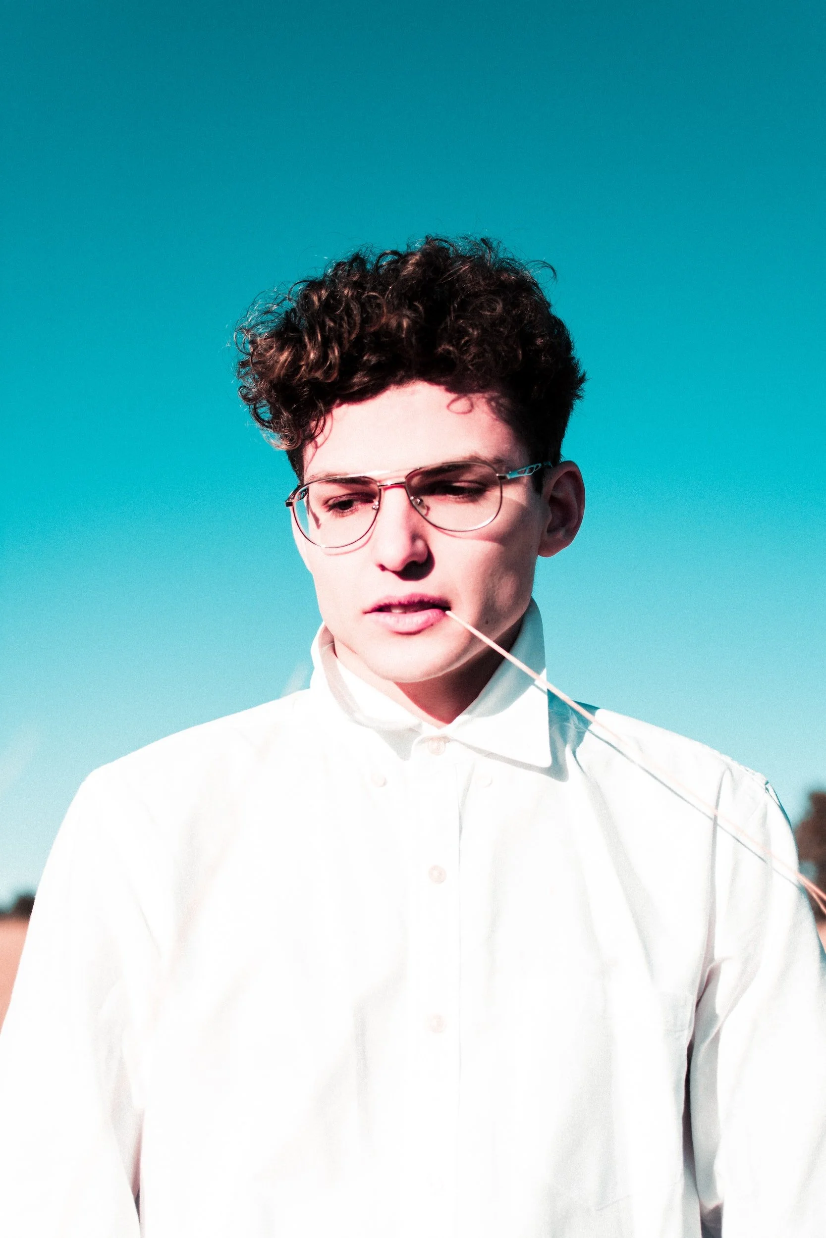 Young person with curly short hair.