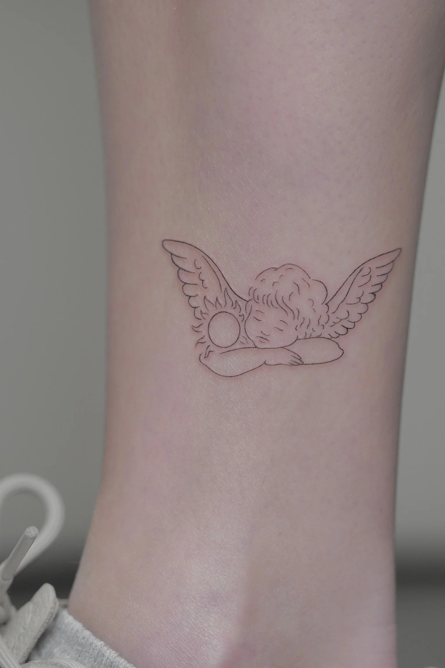 julia-fineline-cherub-angel-ankle-tattoo-soho-nyc-uplift.jpg