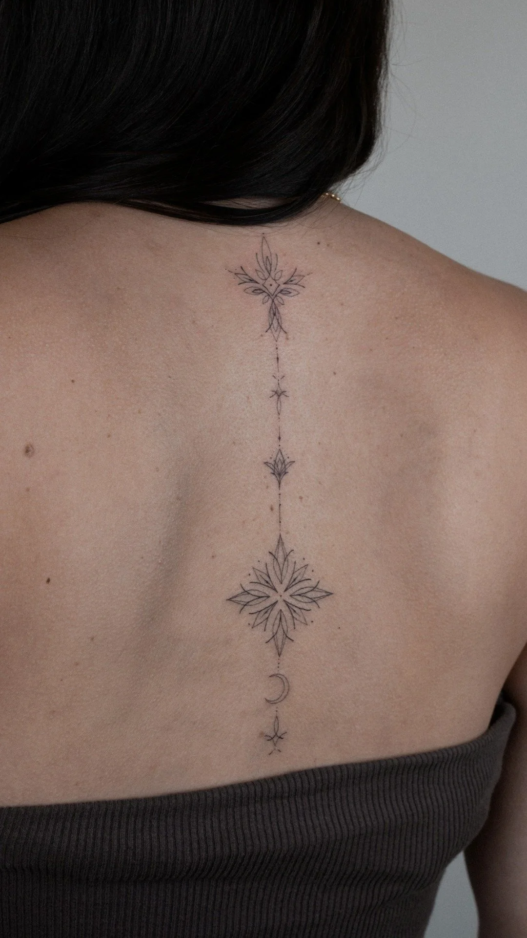 fine-line-spine-tattoo-ornamental-back-uplift.jpg