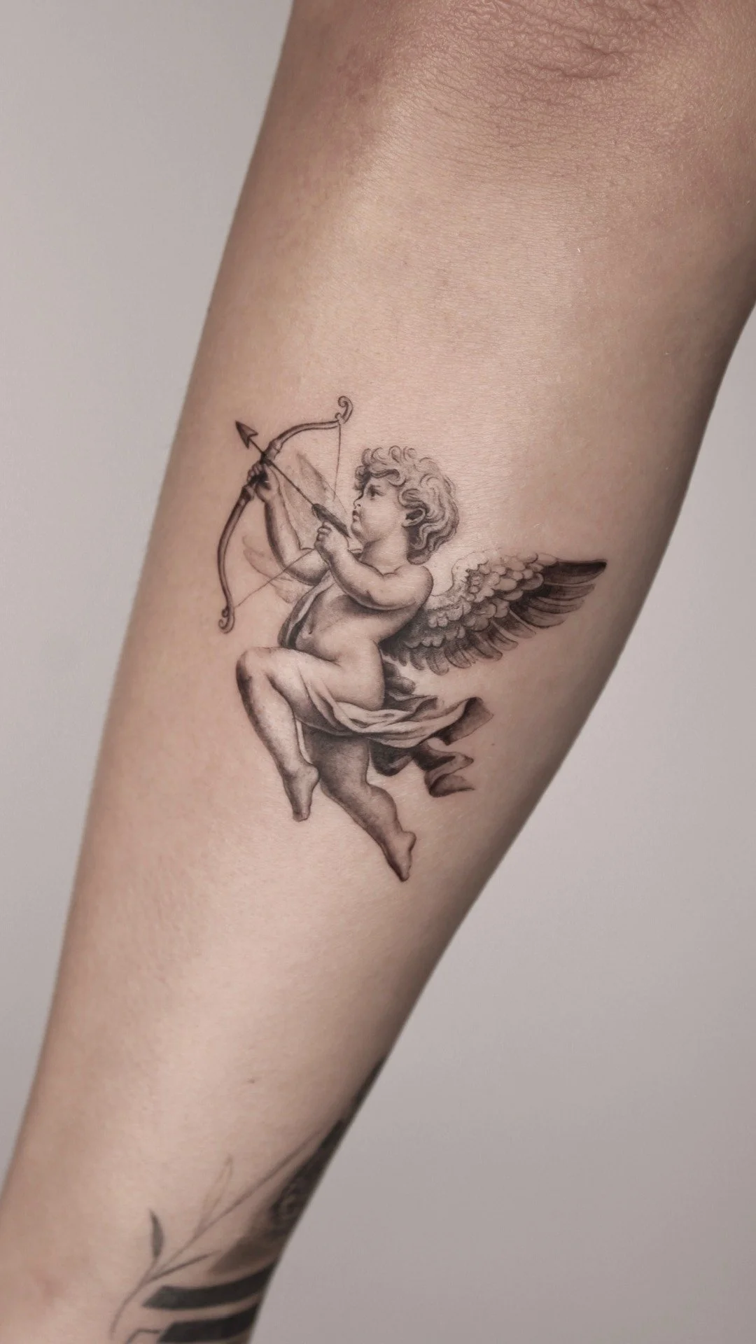 first-tattoo-nyc-fine-line-cherub-arm-uplift.jpg