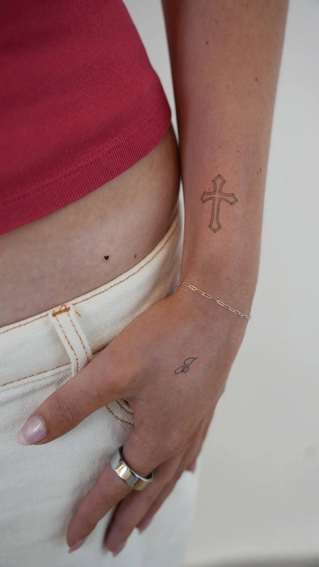 first-tattoo-nyc-small-cross-initial-hand-uplift.jpg