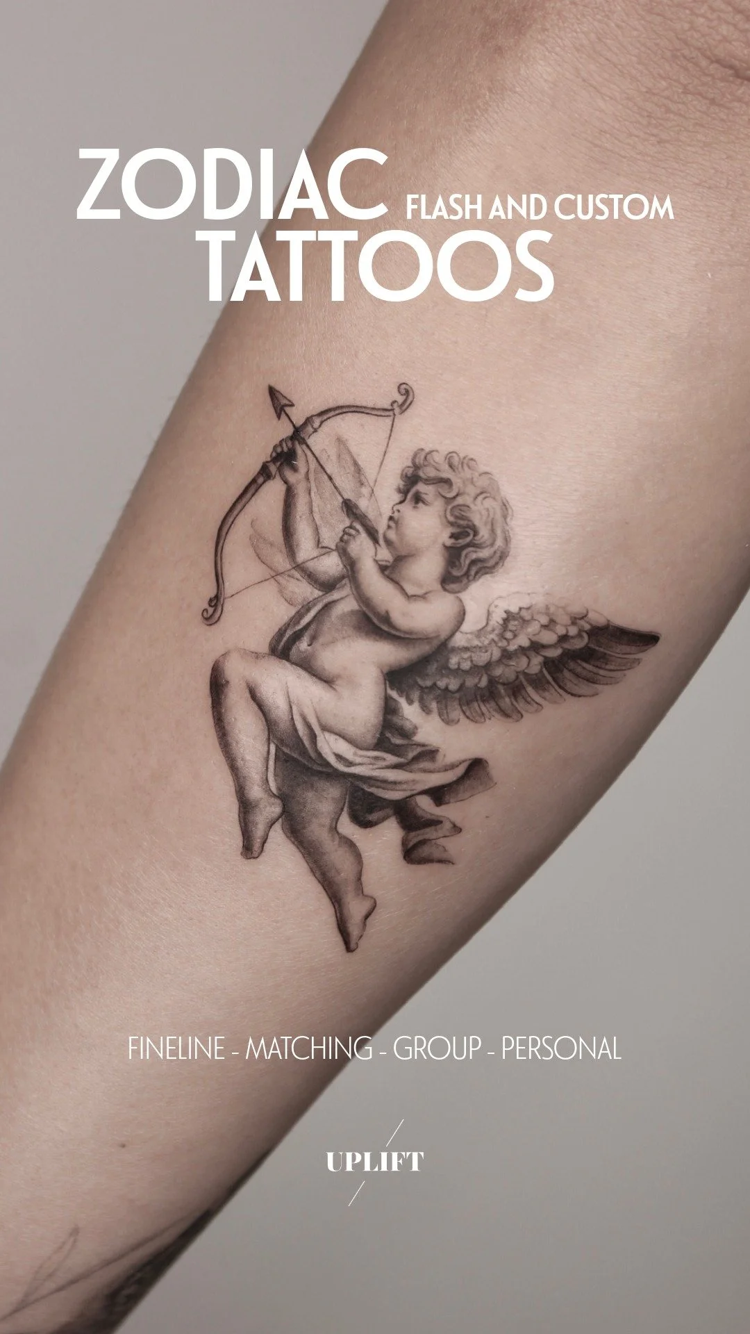 Tattoo of a cherub with wings drawing a bow and arrow on a person's arm.