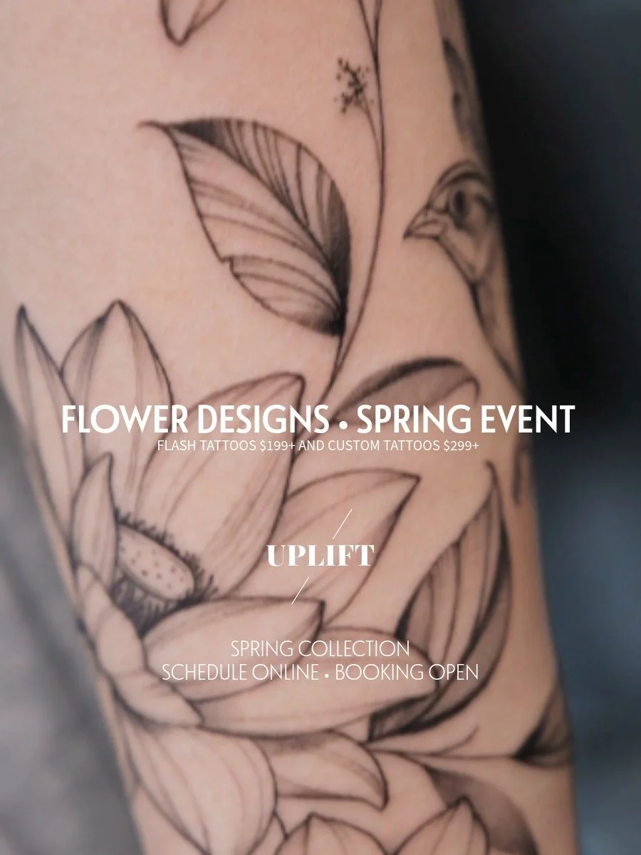 Close-up of a black and gray floral tattoo on a person's arm, featuring detailed leaves and flowers.