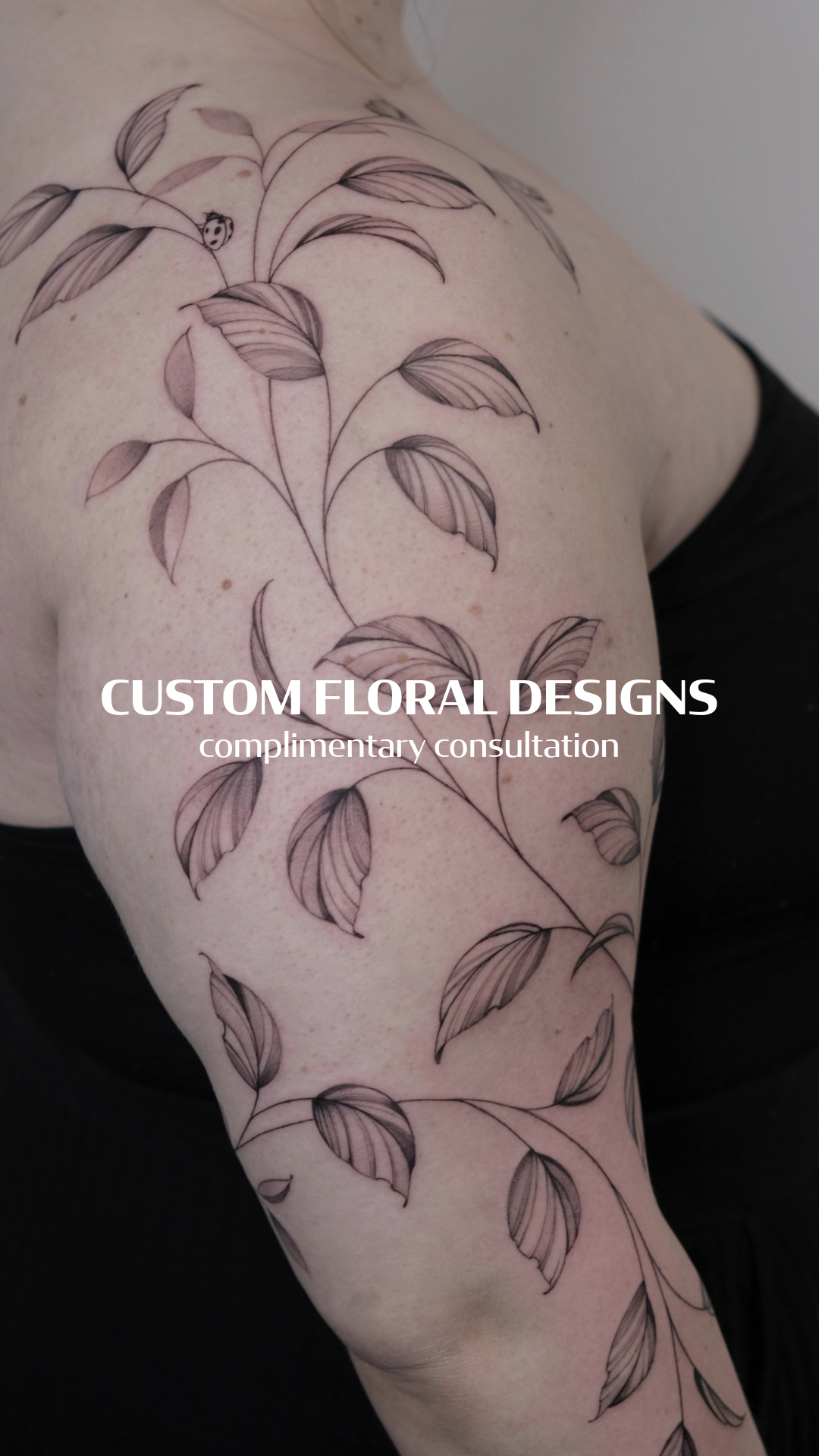 Close-up of a person's arm with a black outline floral tattoo design and overlay text 'Custom Floral Designs, complimentary consultation'.