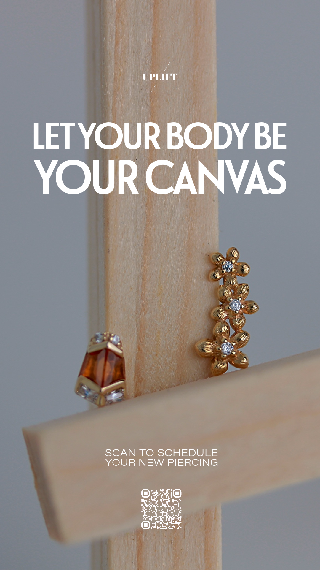 Close-up of gold jewelry with rhinestones, displayed on a wooden stand with text overlay promoting body piercings and scheduling appointments via QR code.