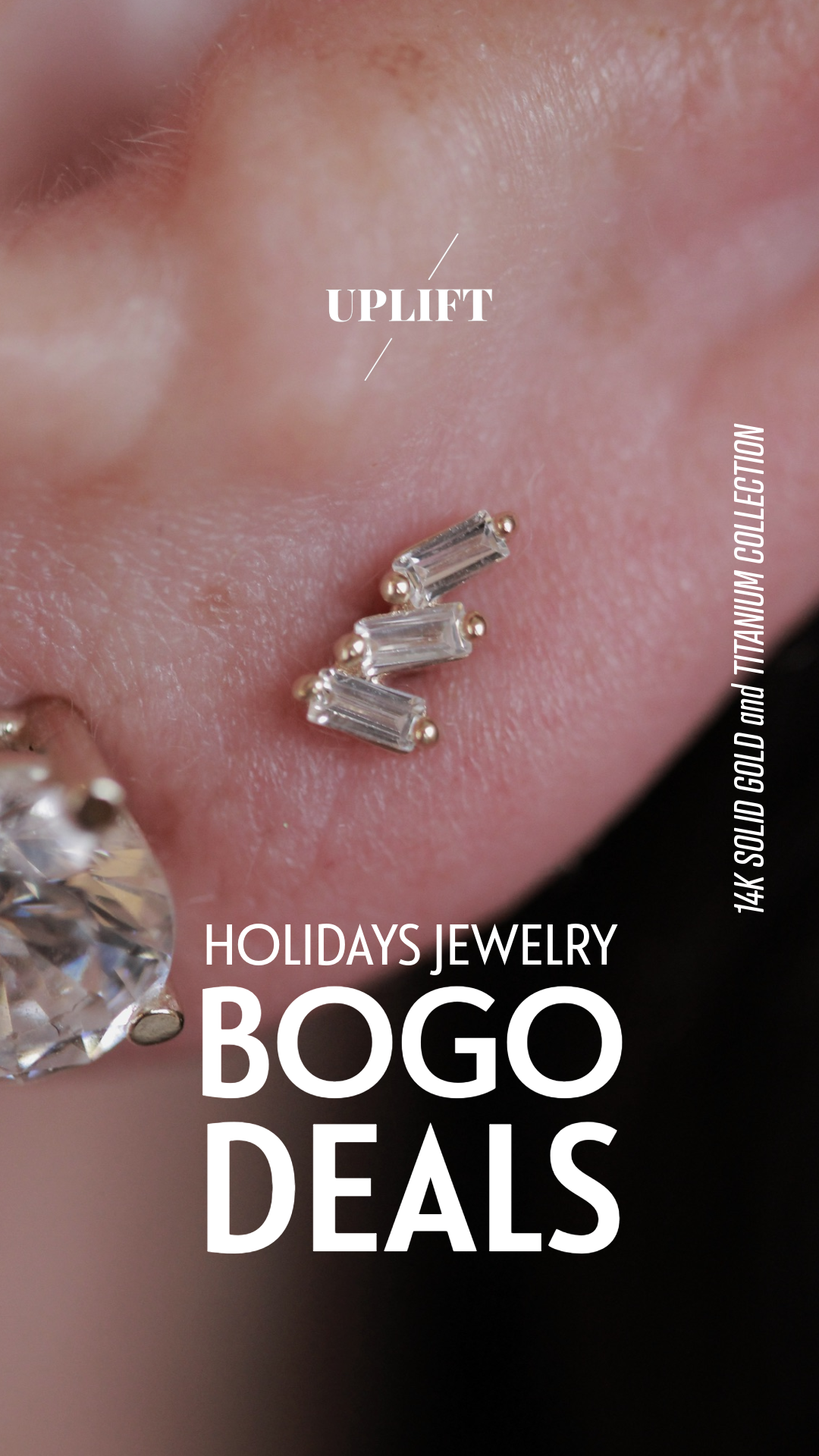 Close-up of a person’s ear with a cartilage piercing, decorated with a piece of jewelry featuring three clear rectangular gemstones set in 14K solid gold and titanium. The image promotes holiday jewelry BOGO deals, highlighting the jewelry's material