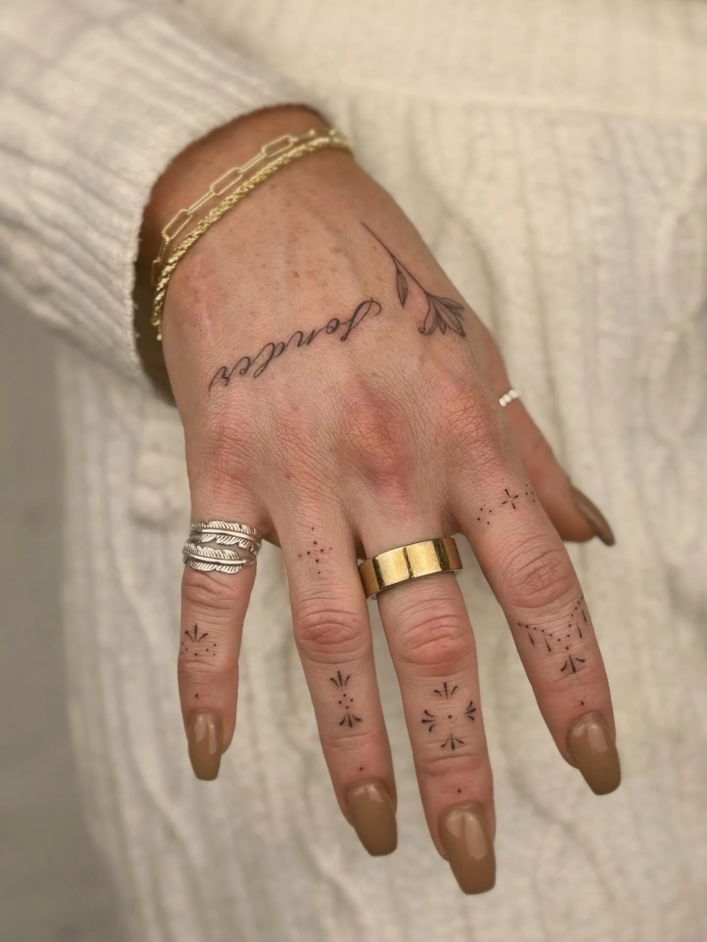 fineline tattoos on hand and fingers in soho