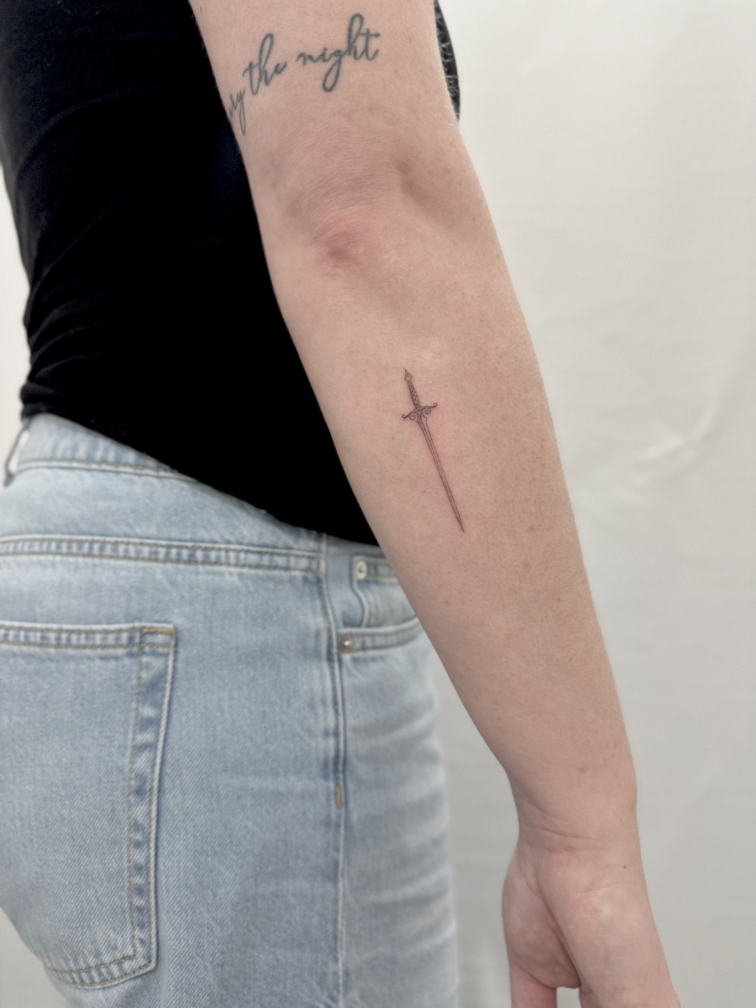 julia-fineline-dagger-script-lettering-tattoo-soho-nyc-uplift.jpg