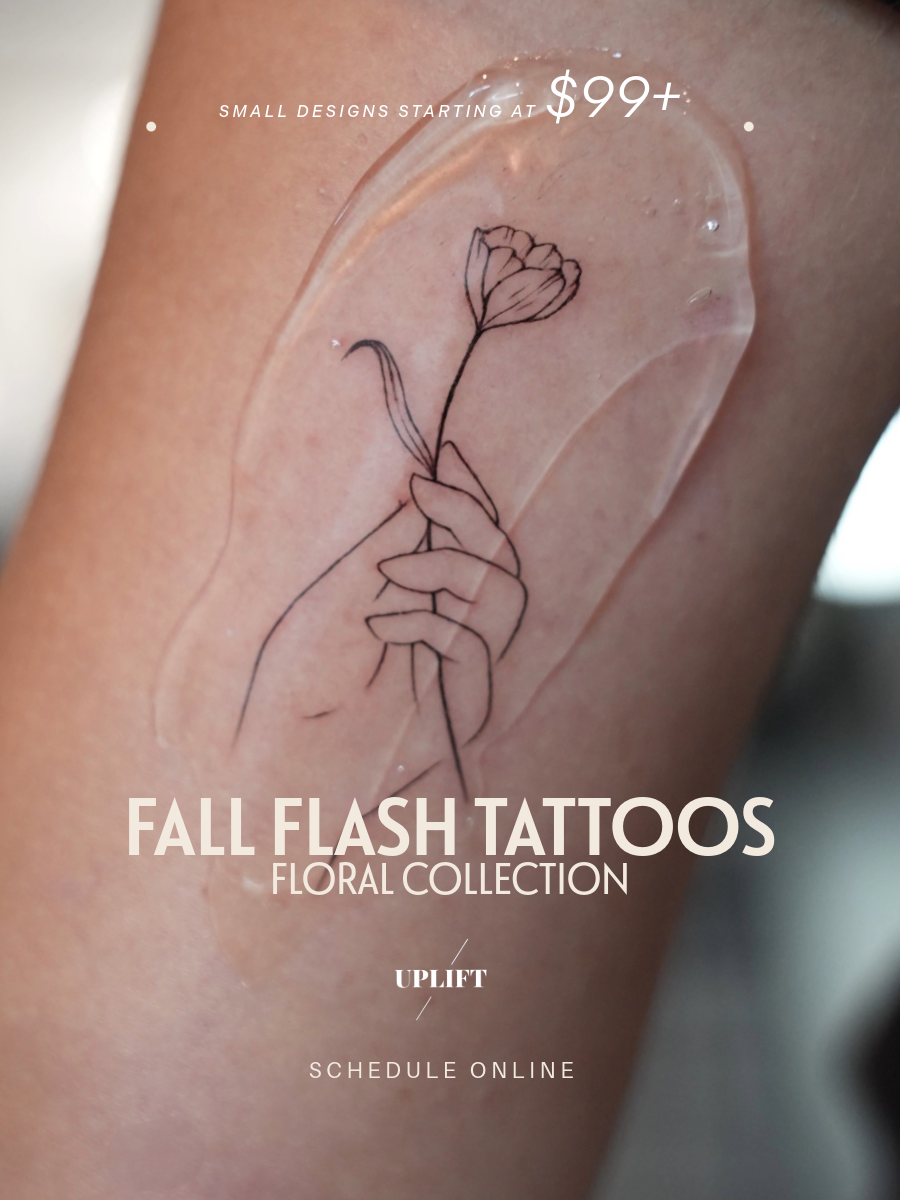 Close-up of a tattoo of a hand holding a flower on skin, with overlay text promoting fall flash tattoos starting at $99, floral collection, and options to schedule online.