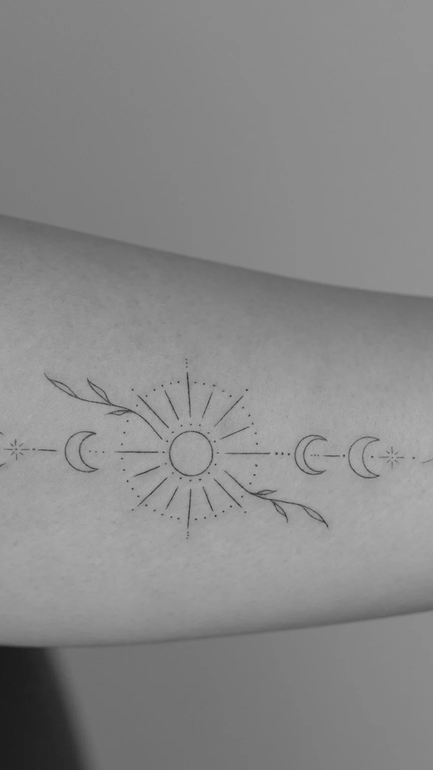 Simple black line drawing of the sun with small dots and lines radiating outward, flanked by crescent moons and small stars, with leaf motifs on neighboring lines.